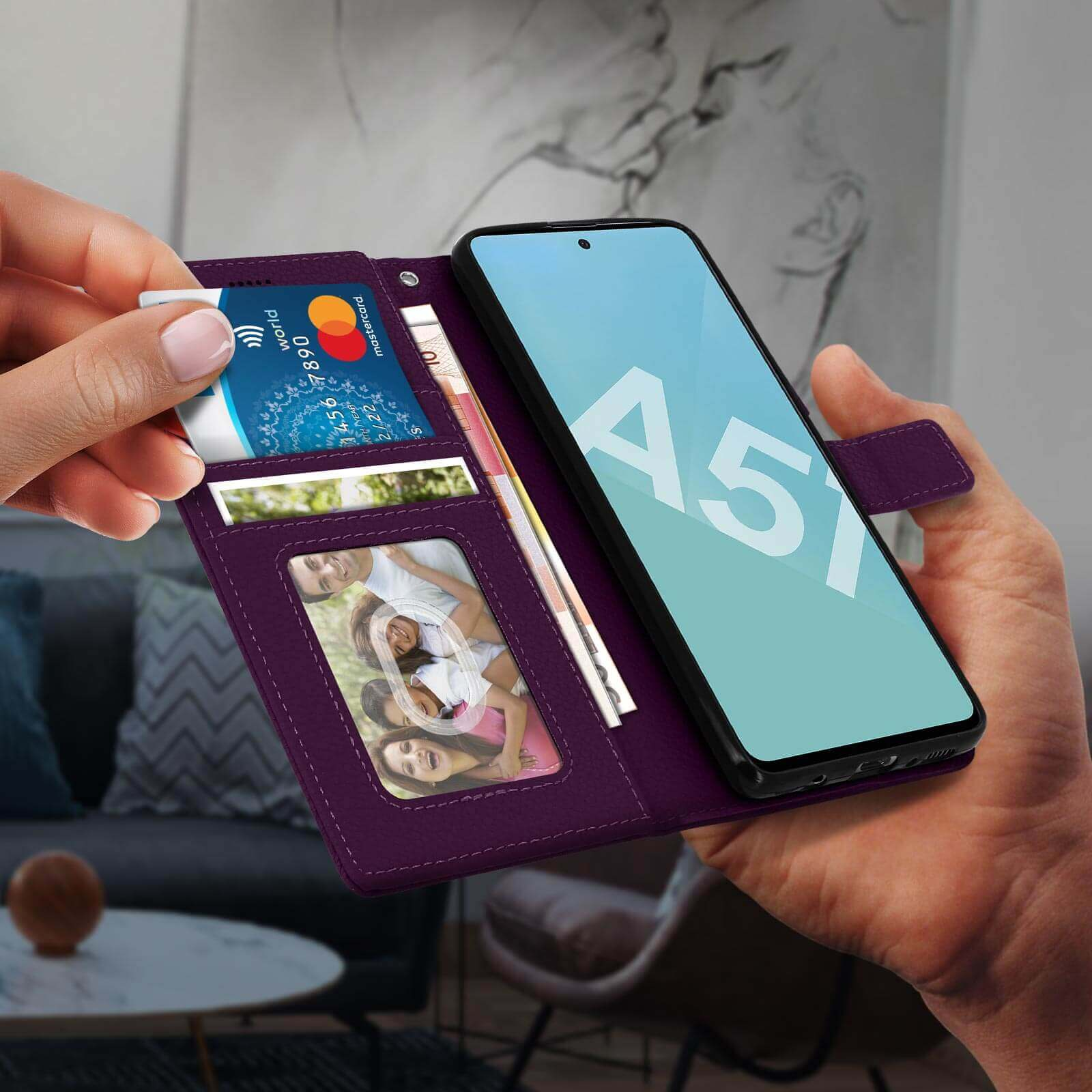 Main ouvrant un étui de téléphone violet révélant cartes et photo. Téléphone à droite.