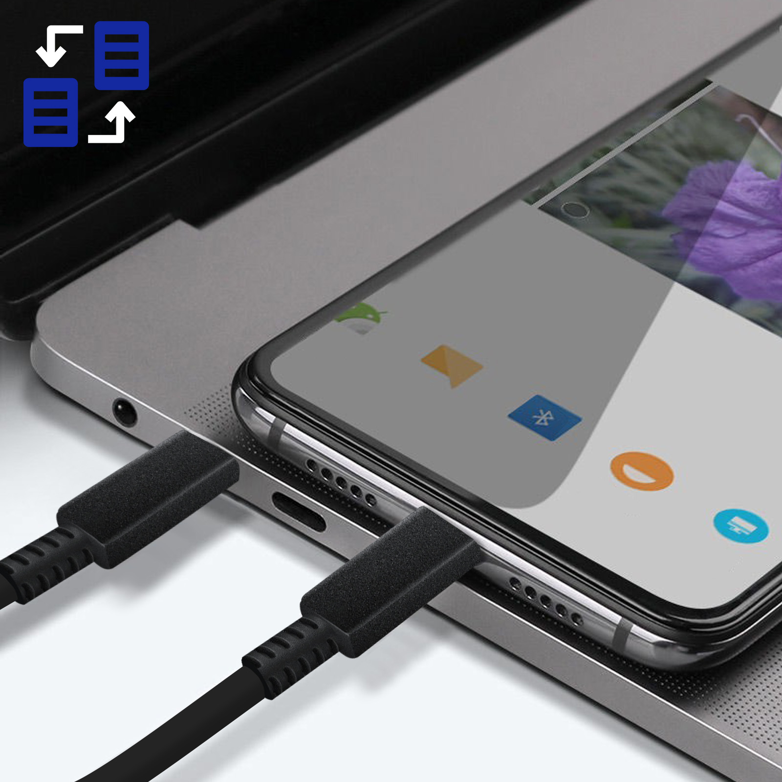 A phone charging on a laptop. Black charging cable and a phone with a flower image.