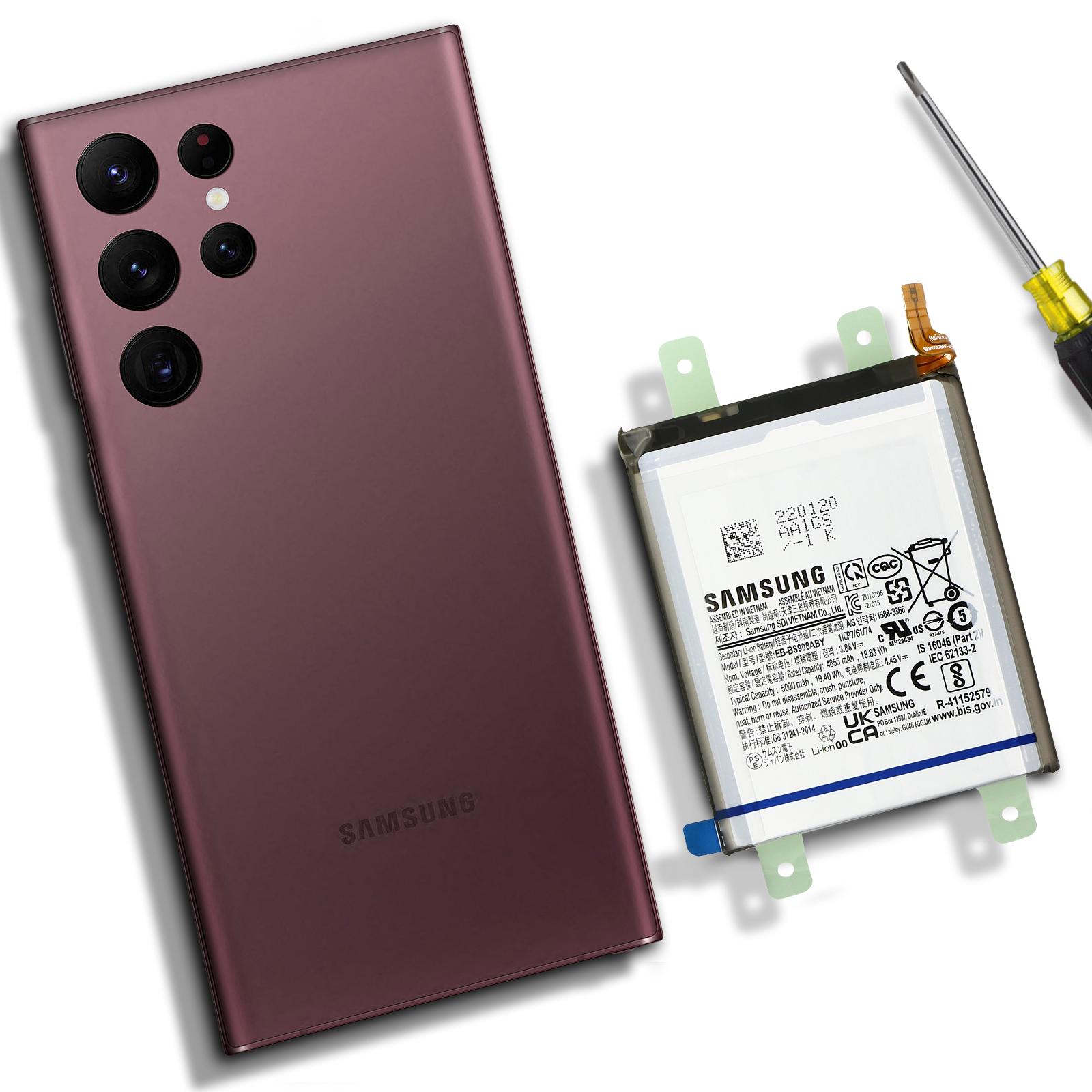 Un téléphone et une batterie, à côté d'un tournevis. Le téléphone est violet.