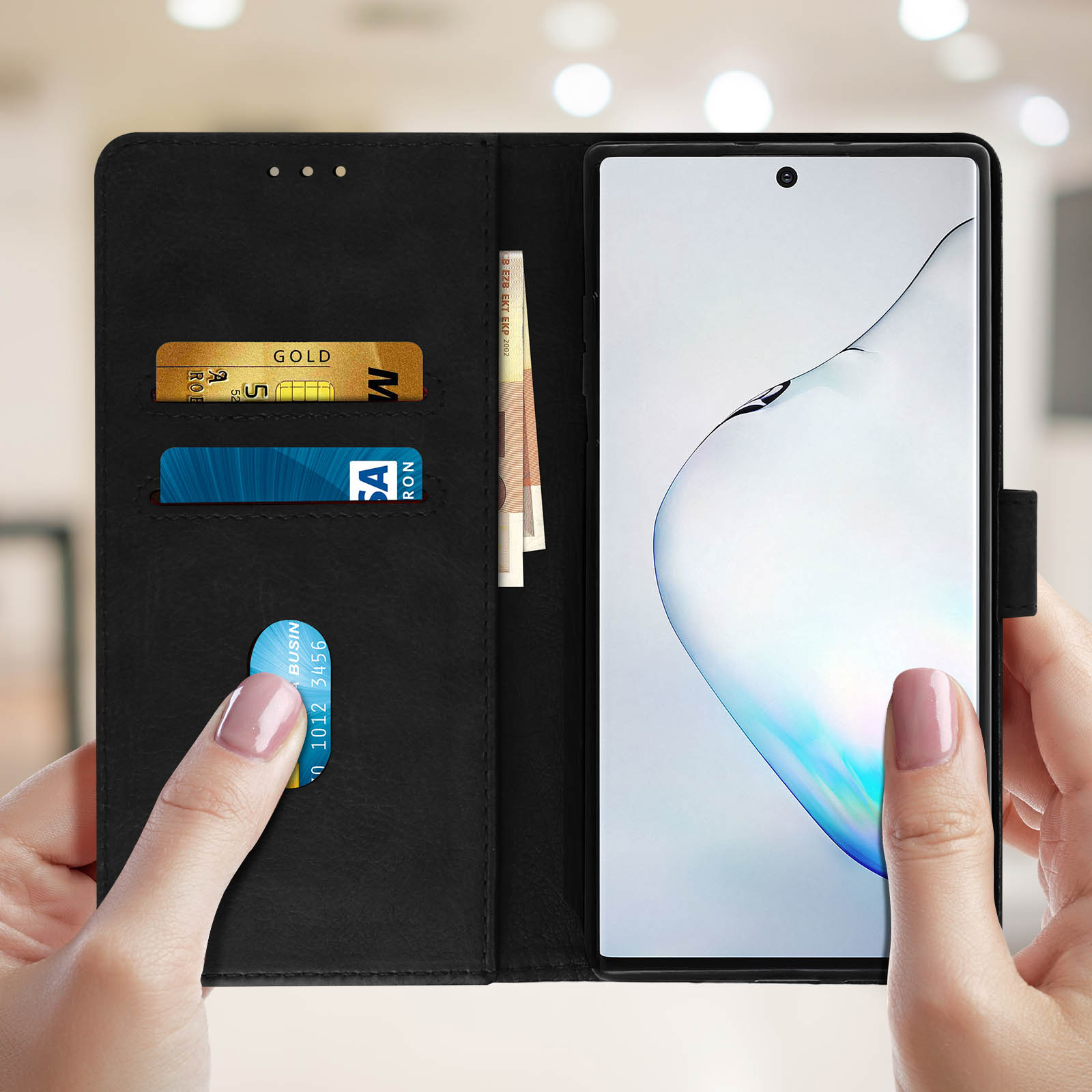 Handen die een zwarte telefoonhoes vasthouden, met kaarten, geld en een smartphone.