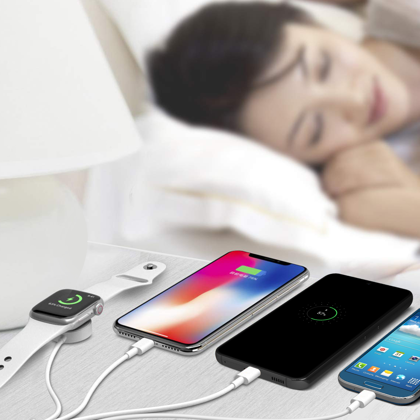 Donna che dorme a letto. Vicino, orologio e telefoni in carica. Mostra il 63% e il 57% di carica.