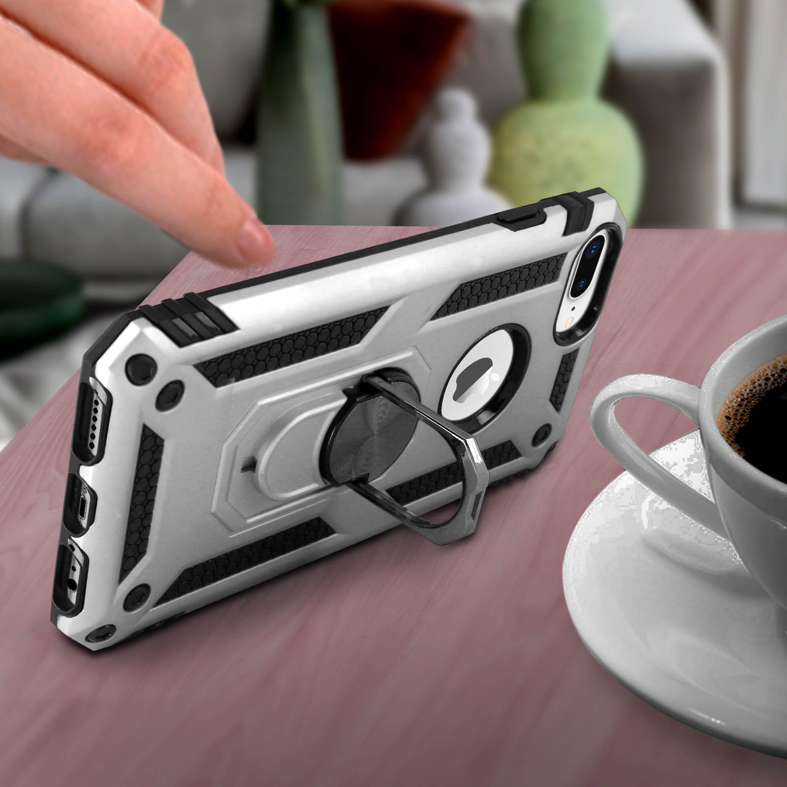 Coque de téléphone argentée avec anneau, avec café sur une table.