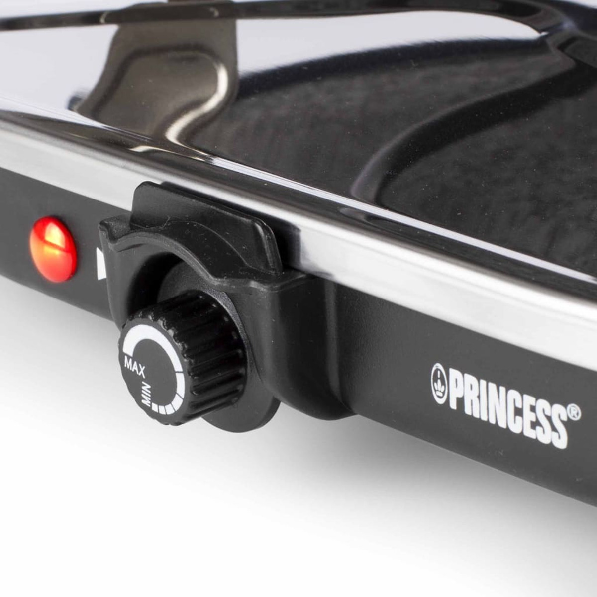 Czarne urządzenie do gotowania z pokrętłem regulacji temperatury z oznaczeniami MAX i MIN oraz czerwonym światłem.