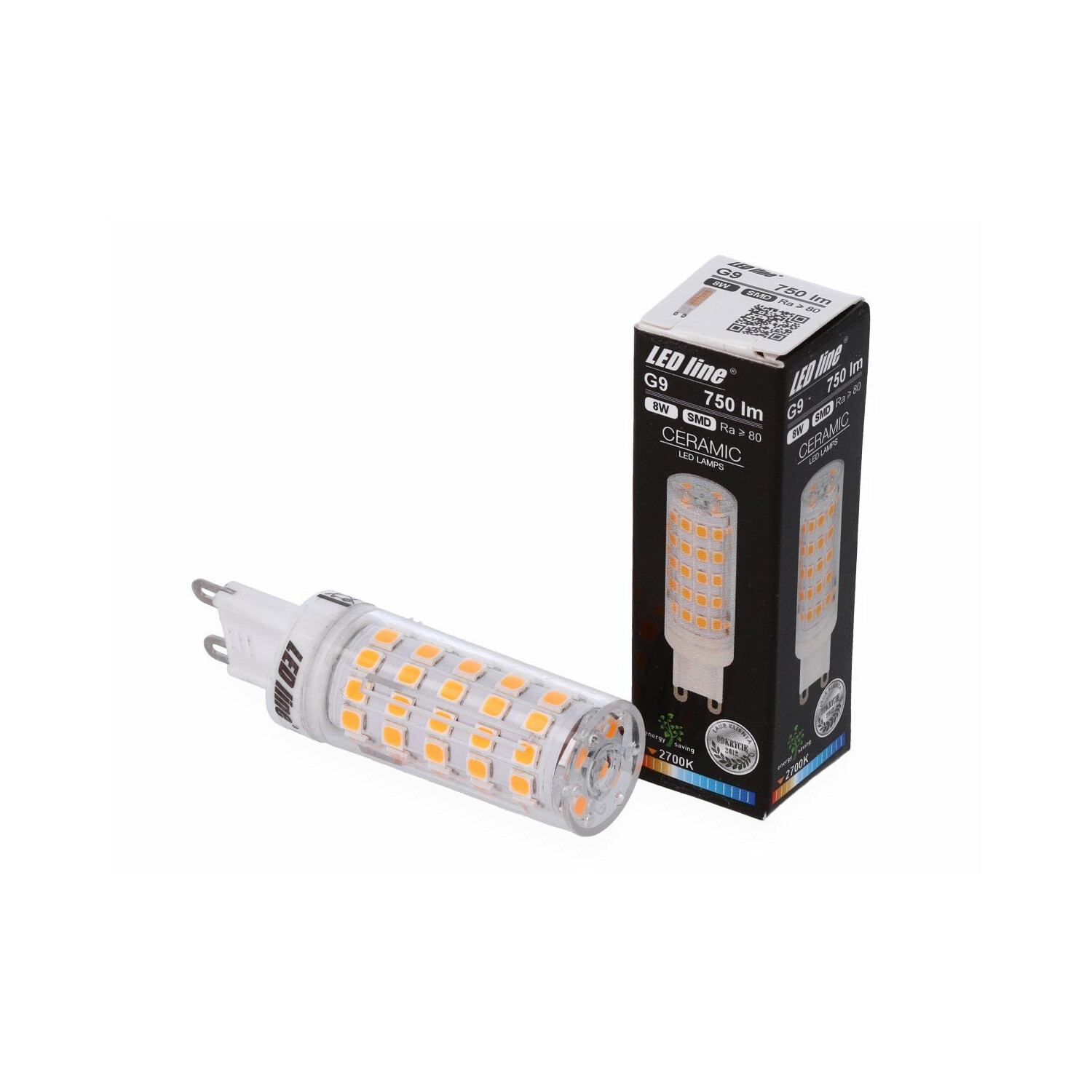 Eine LED-Lampe und ihre Schachtel. Die Lampe ist orange, die Schachtel schwarz-weiß. Die Schachtel hat Details.