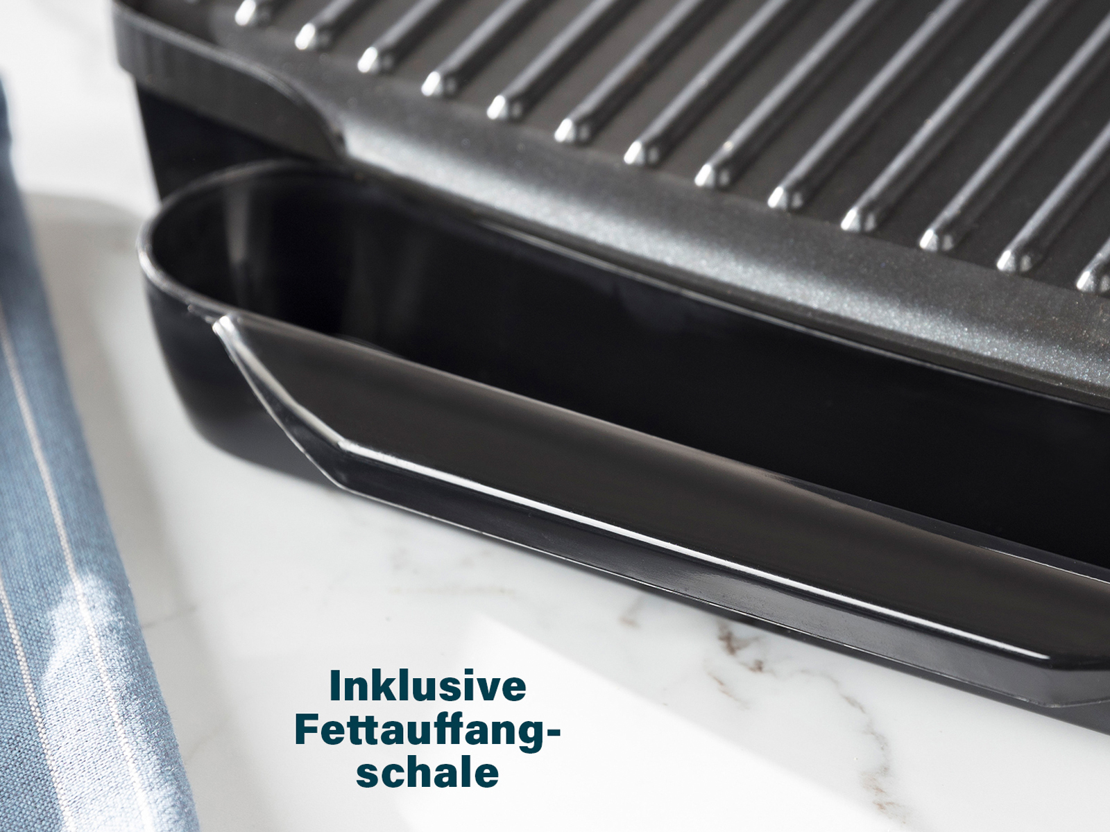 Nahaufnahme der Fettauffangschale eines schwarzen Panini-Grills mit Text: 'Inklusive Fettauffangschale'.