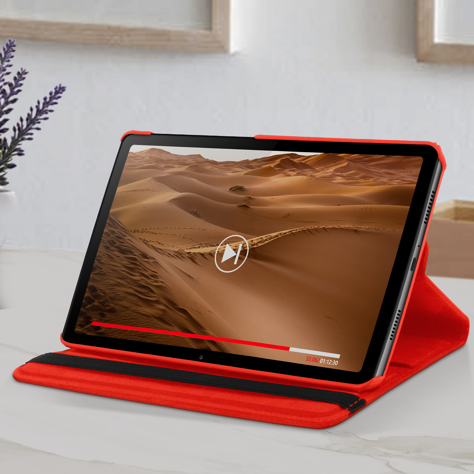 Tablet con custodia rossa che mostra un video del deserto. Pulsante play visibile.