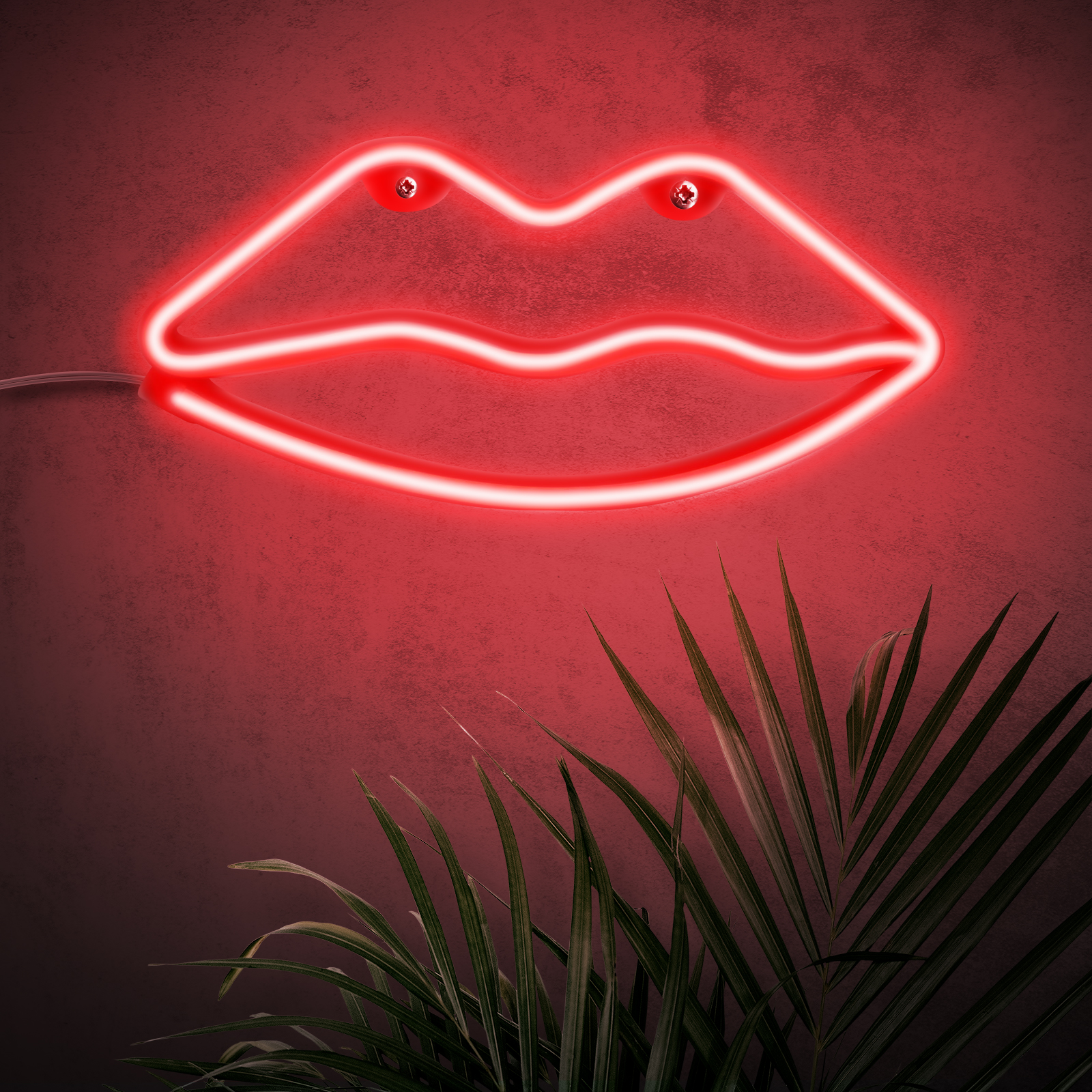 Labios rojos de neón en una pared roja. Una planta en primer plano.
