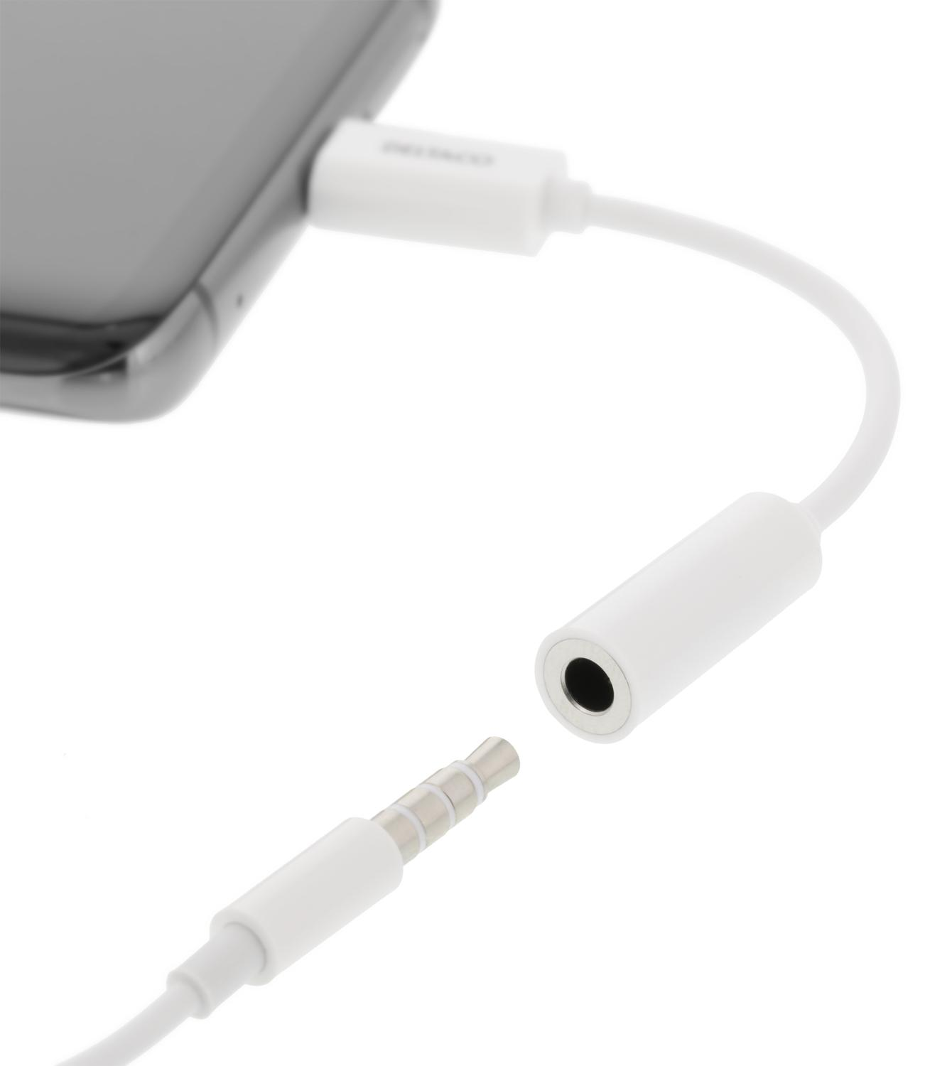 Adattatore audio bianco collegato a un telefono. Jack per cuffie bianco.