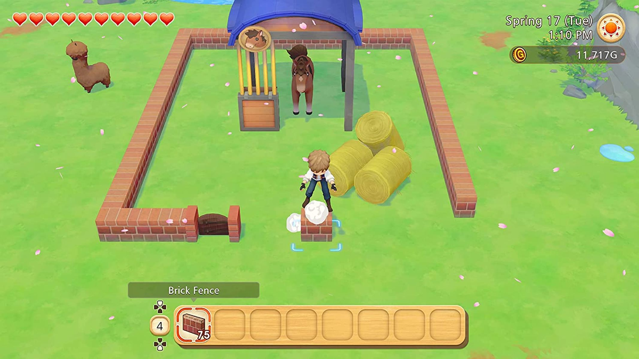 Eine Farm-Szene aus einem Videospiel. Eine Figur baut einen Ziegelzaun. Ein Pferd ist im Stall.