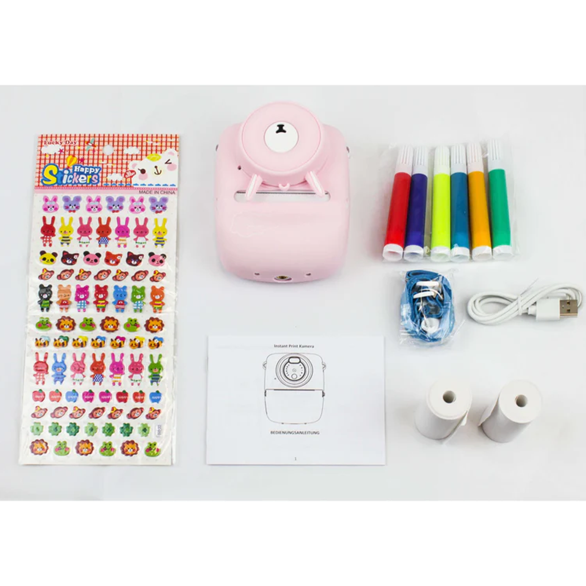 Rosa Sofortbildkamera-Set mit Aufklebern, Markern, Papierrollen und Kabel.
