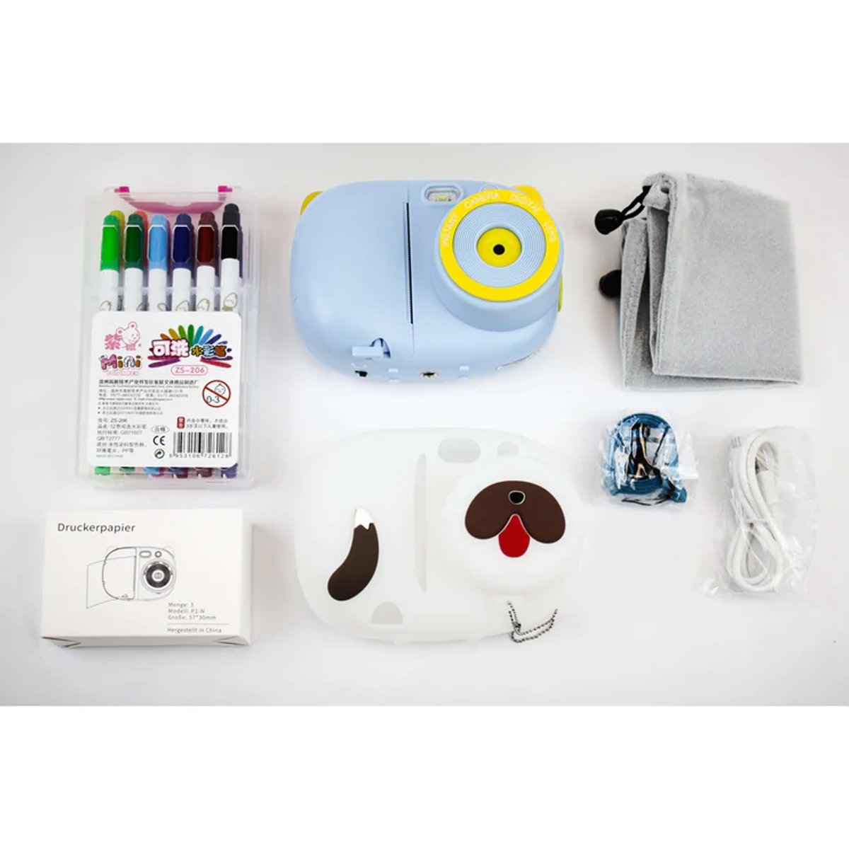 Inhalt eines Geschenksets: Sofortbildkamera, Marker, Hülle, Film und weiteres Zubehör.