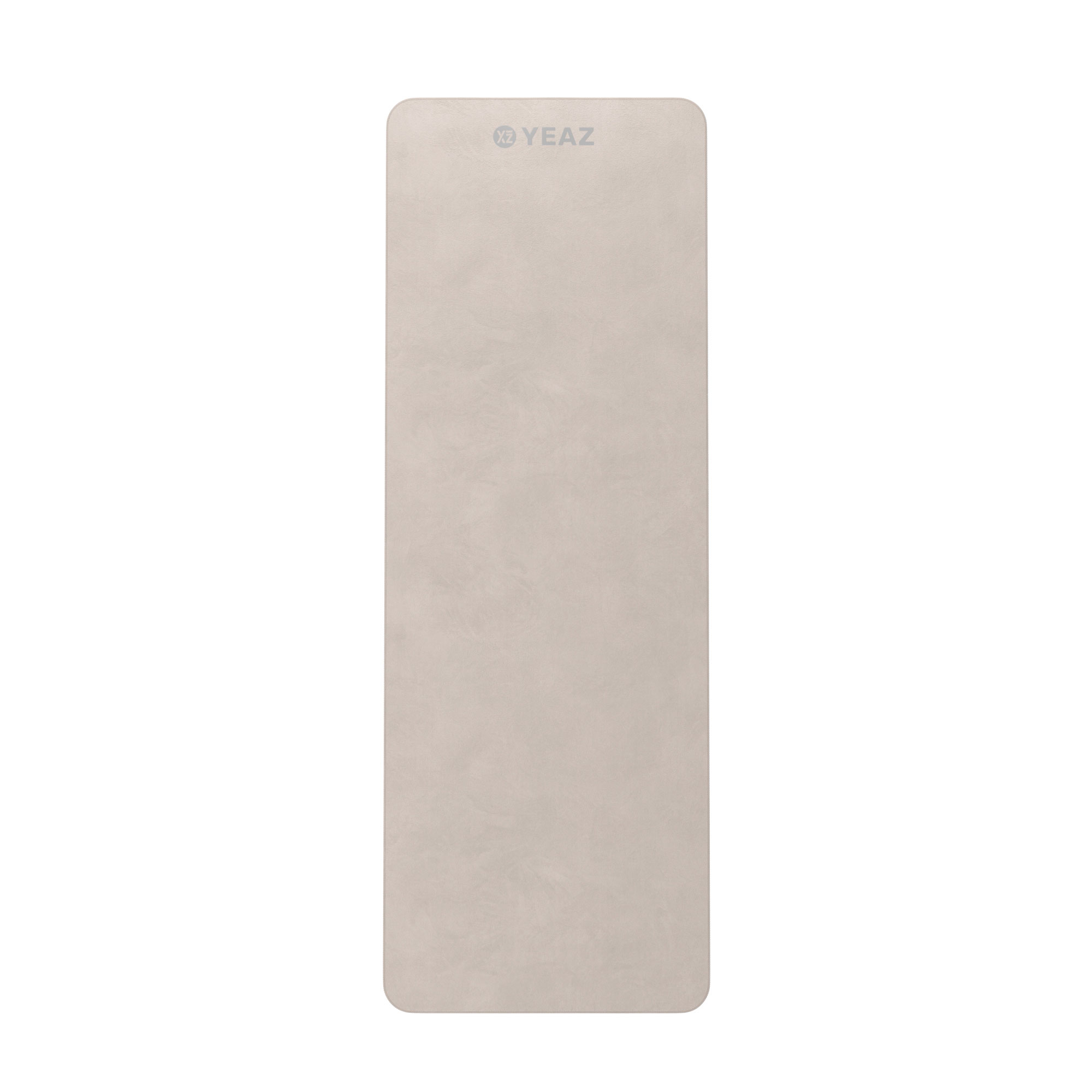 Eine hellbeige Yogamatte mit dem Markennamen 'YEAZ' aufgedruckt.