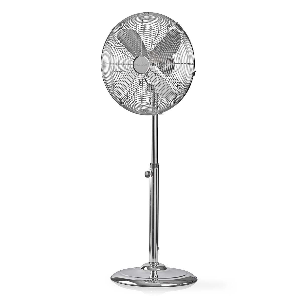 Ventilatore a piantana argentato. Tre pale. Supporto e base cromati. Sfondo bianco.