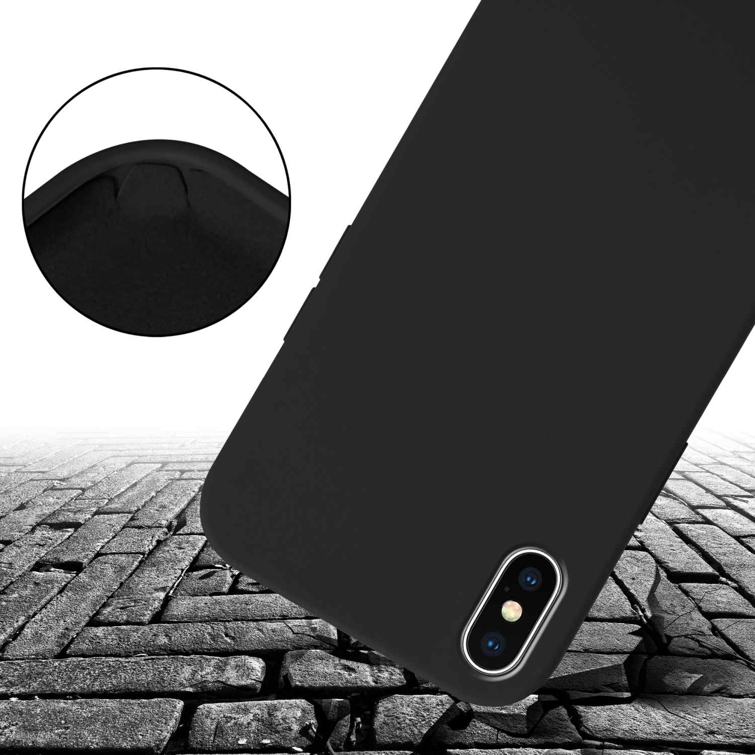 Una custodia per telefono nera con un'ammaccatura visibile sull'angolo, su una superficie simile a un mattone.
