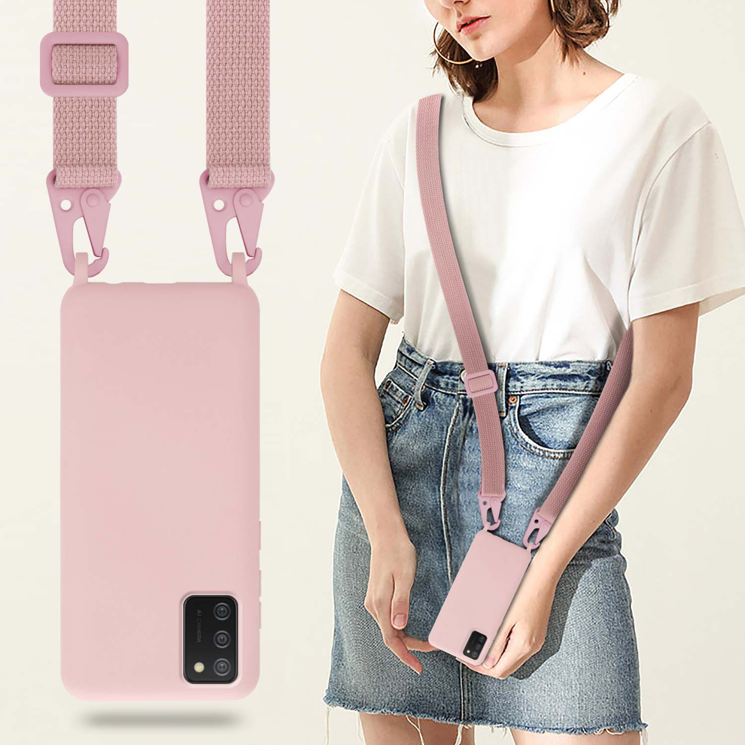 Una donna modella una custodia per telefono rosa con un cinturino abbinato, telefono in mano.