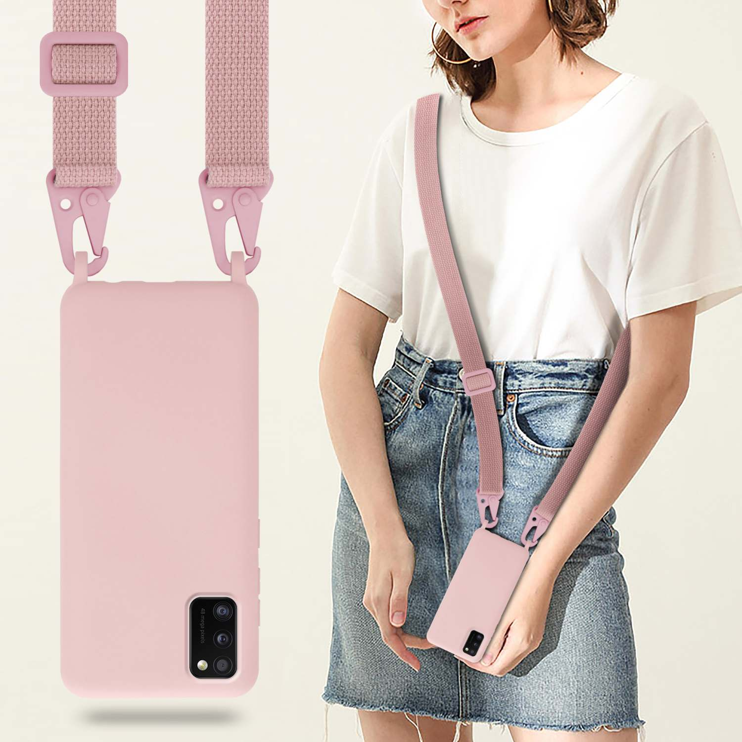 Donna con custodia rosa per telefono e cinturino abbinato. Indossa una camicia bianca e jeans.