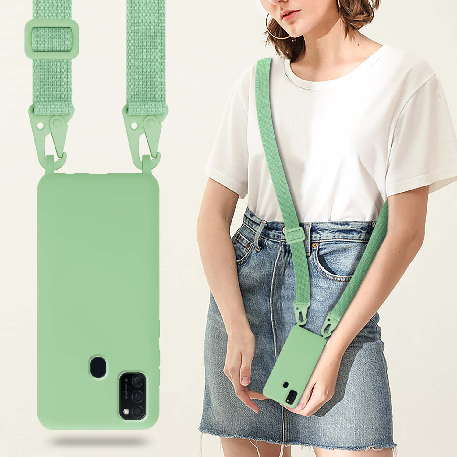 Una donna tiene una custodia verde per telefono con cinturino. La custodia e il cinturino sono verde menta.