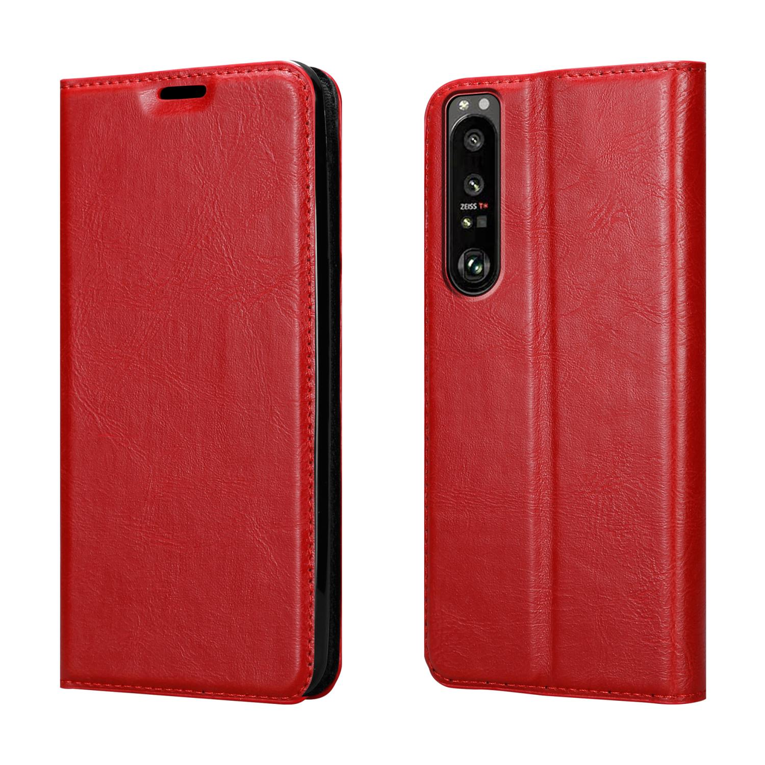 Custodia rossa, aperta. Il telefono è visibile e una custodia chiusa sullo sfondo.
