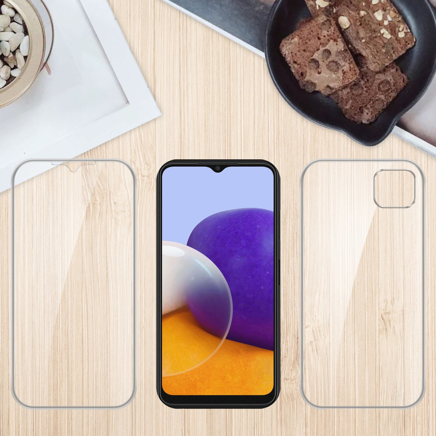 Telefono con protezione schermo, custodia e brownies su un tavolo di legno. Accessori mostrati.