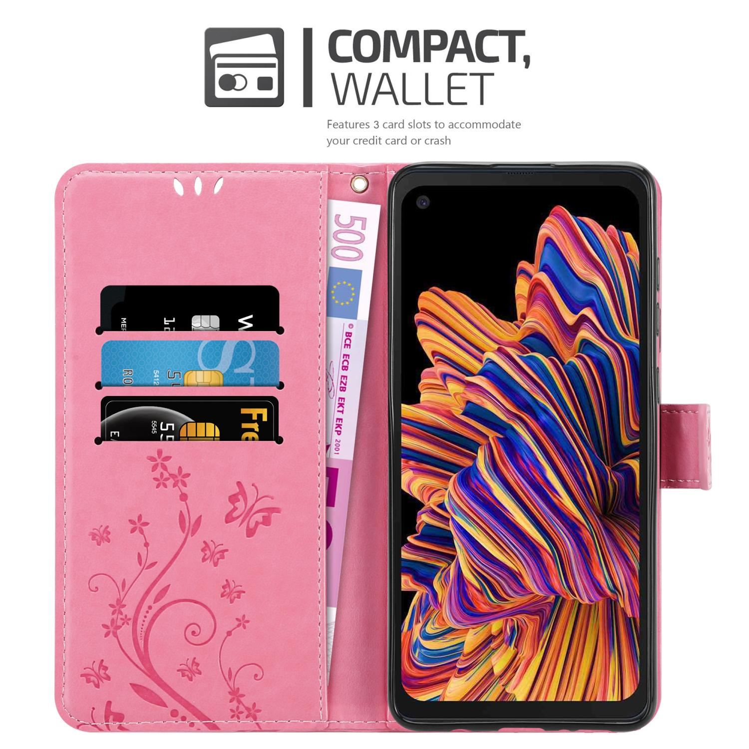 Custodia per telefono rosa, aperta, con carte, denaro e telefono che mostra arte astratta colorata.