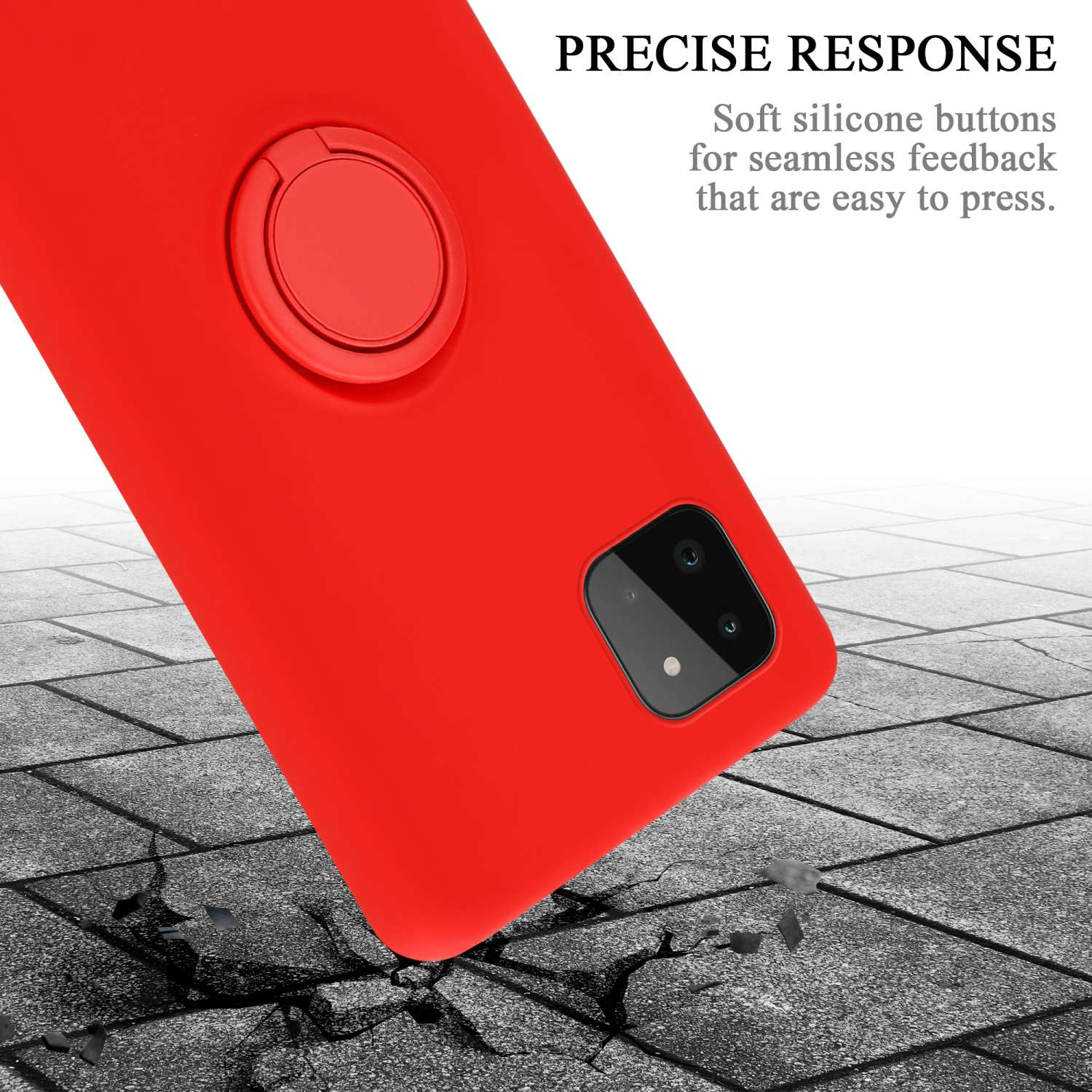 Custodia rossa con anello e fotocamera, su superficie grigia crepata con detriti.