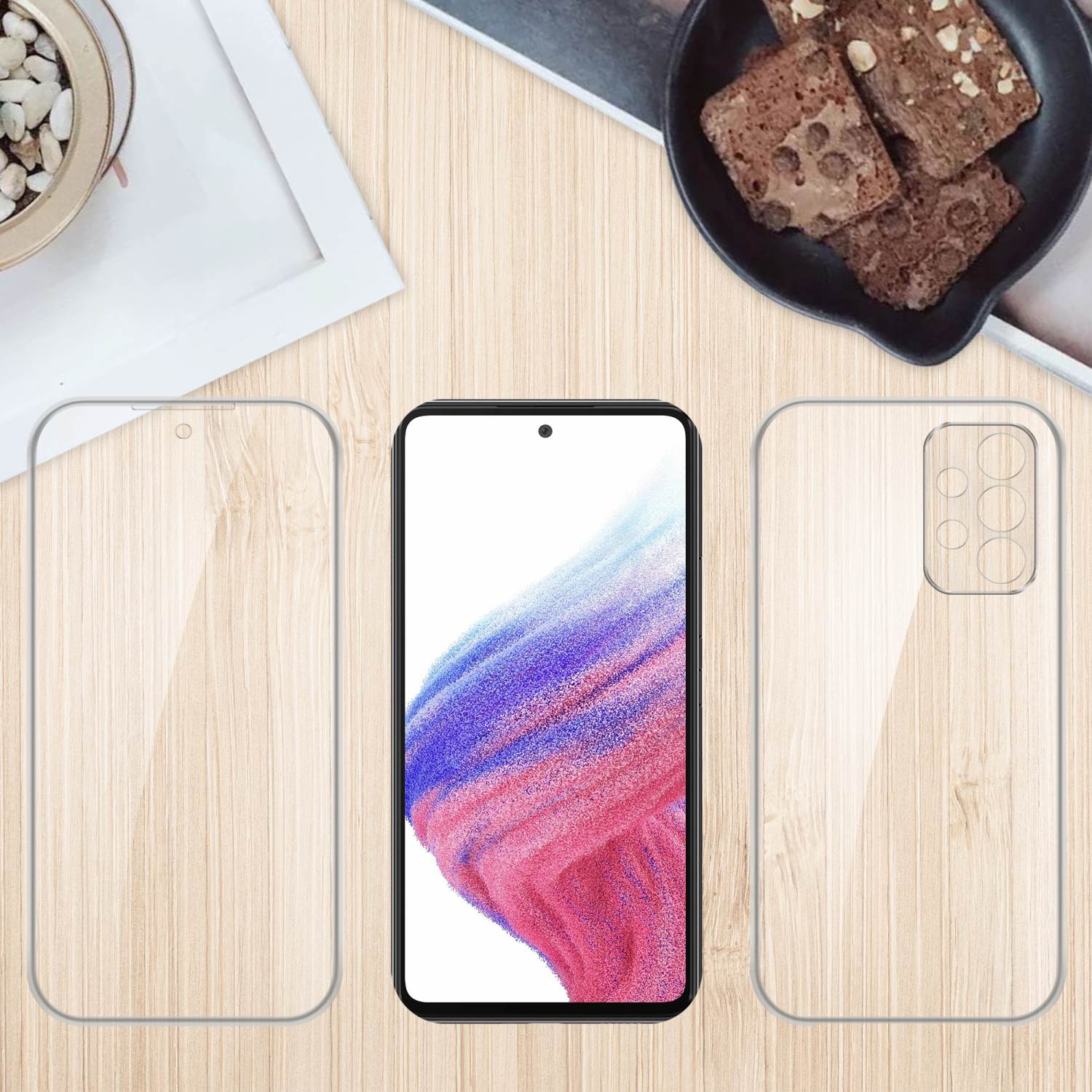Telefon und Displayschutzfolien auf Holzgrund mit kleiner Pflanze und Brownies.