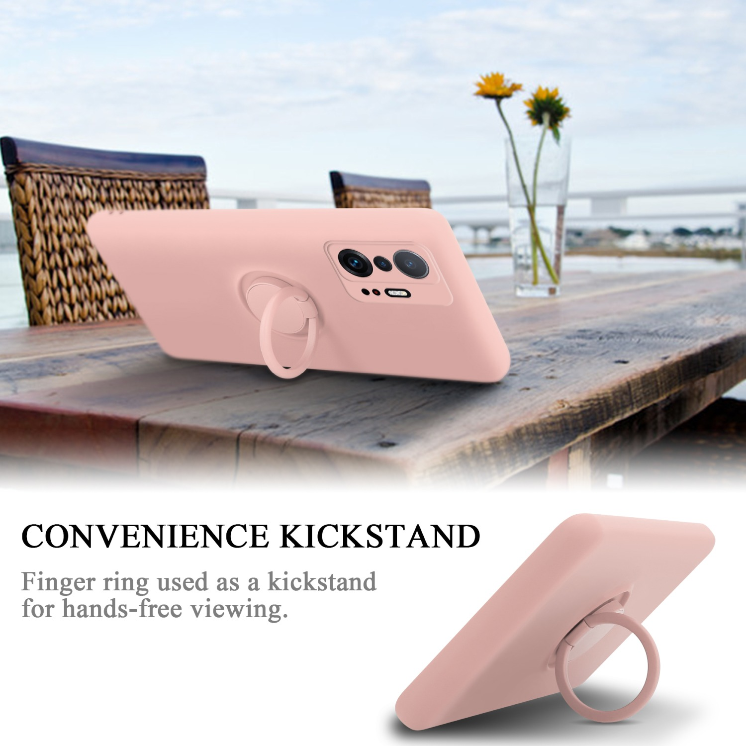 Una custodia per telefono rosa con un supporto ad anello su un tavolo di legno. Un vaso di fiori sullo sfondo.