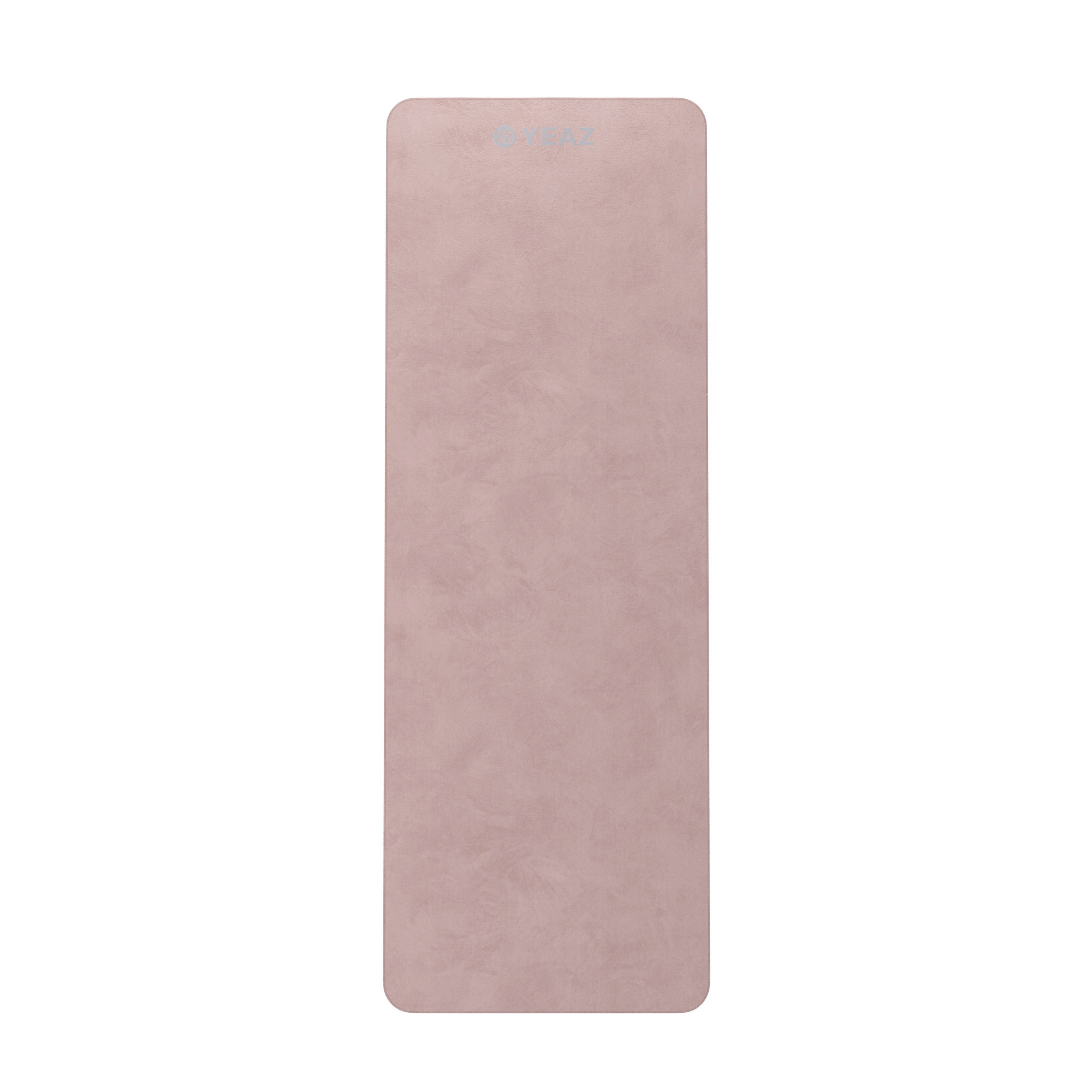Eine rosa Yogamatte auf einer weißen Oberfläche mit strukturierter Oberfläche.