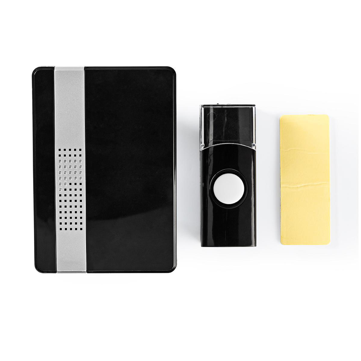 Czarny zestaw dzwonka do drzwi. Zawiera jednostkę główną, przycisk i żółtą podkładkę samoprzylepną.