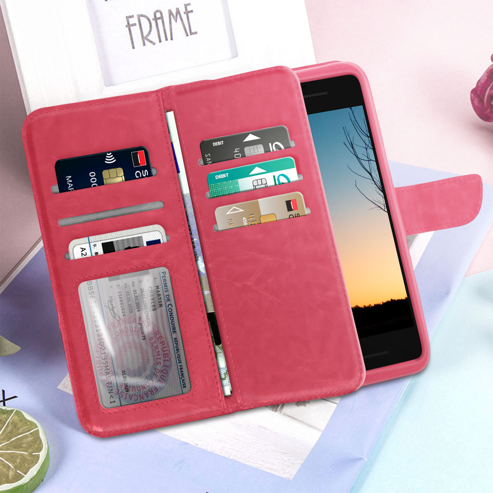 Una custodia per telefono a portafoglio rosa aperta, che rivela carte e un telefono. La custodia è simile alla pelle.