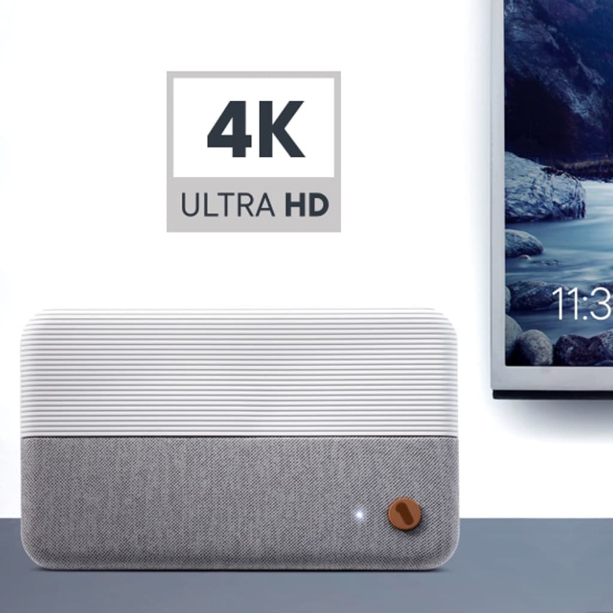 A white and gray speaker with a wooden button is in front of a 4K Ultra HD sign.