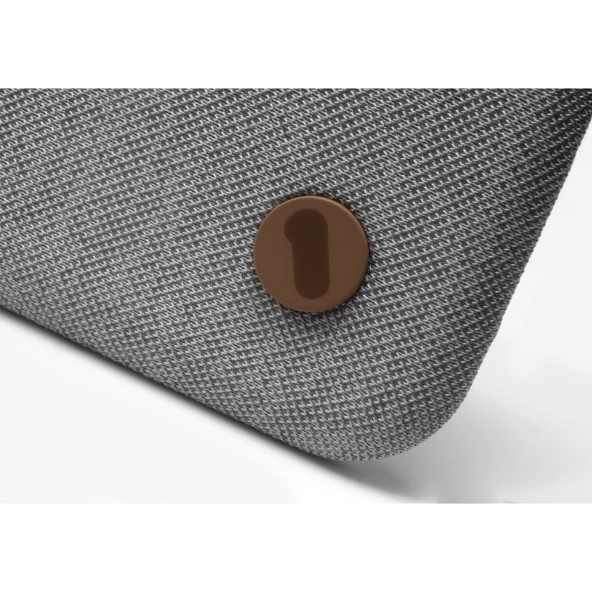 Gray cushion with a brown button. White background.