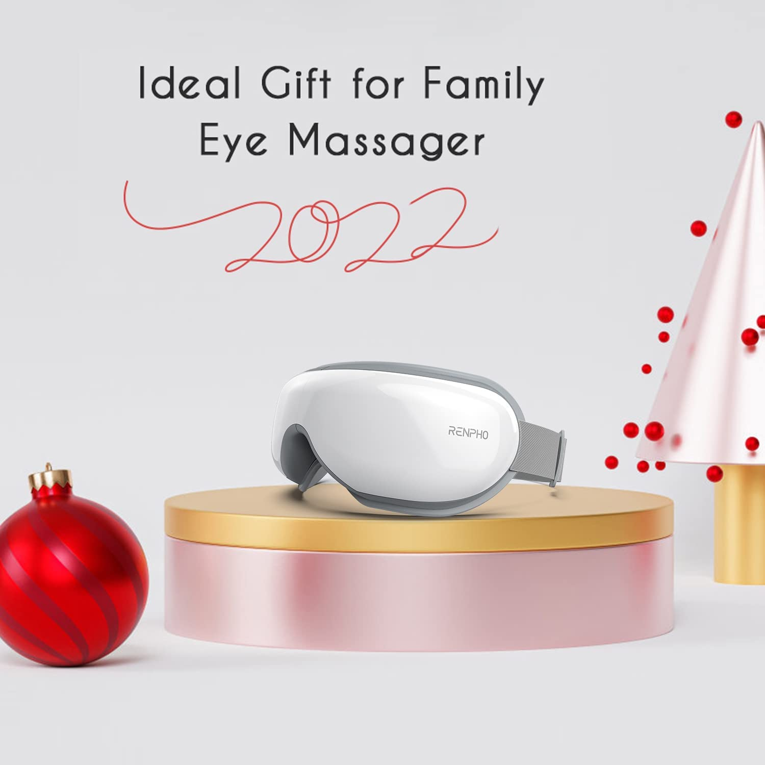 Augenmassagegerät auf Ständer, mit Text und Weihnachtsdekorationen. Weißer Hintergrund.