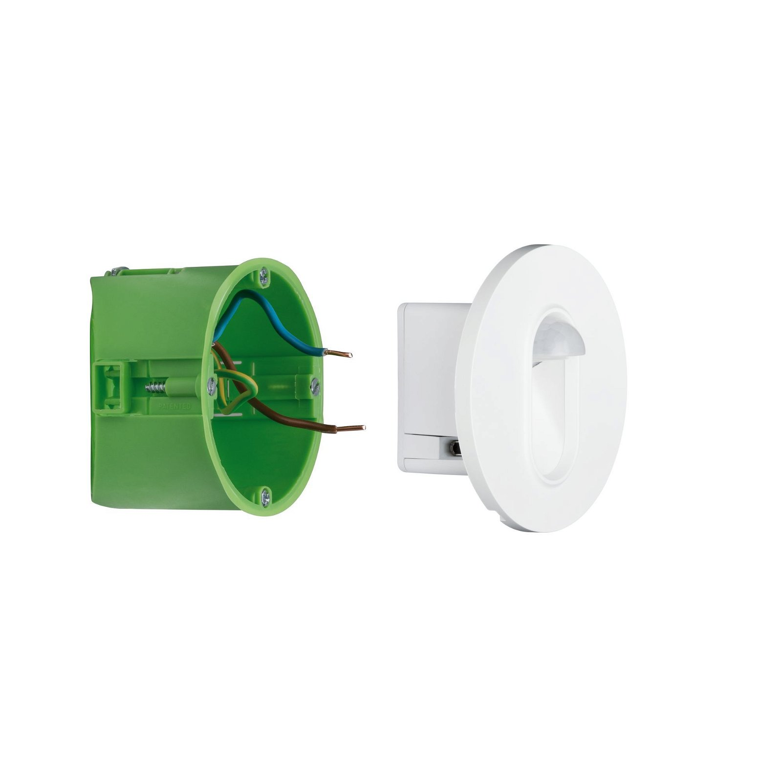 Scatola elettrica in plastica verde con fili accanto a un apparecchio di illuminazione circolare bianco.