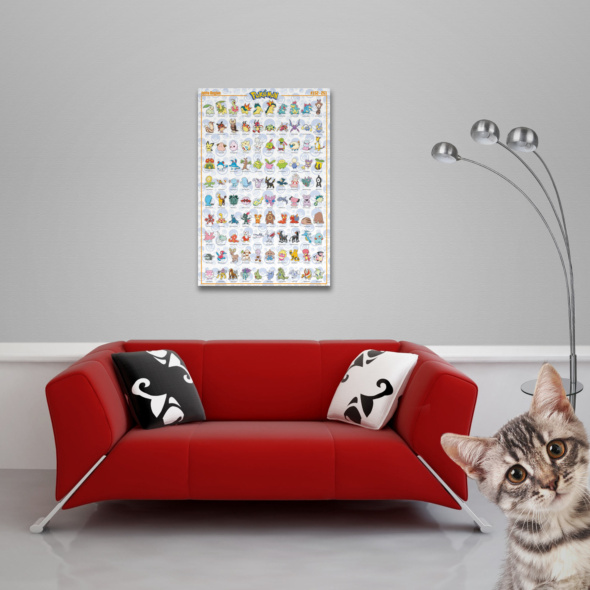Rotes Sofa mit Kissen und Poster mit vielen Pokémons, ein Kätzchen blickt in die Kamera.