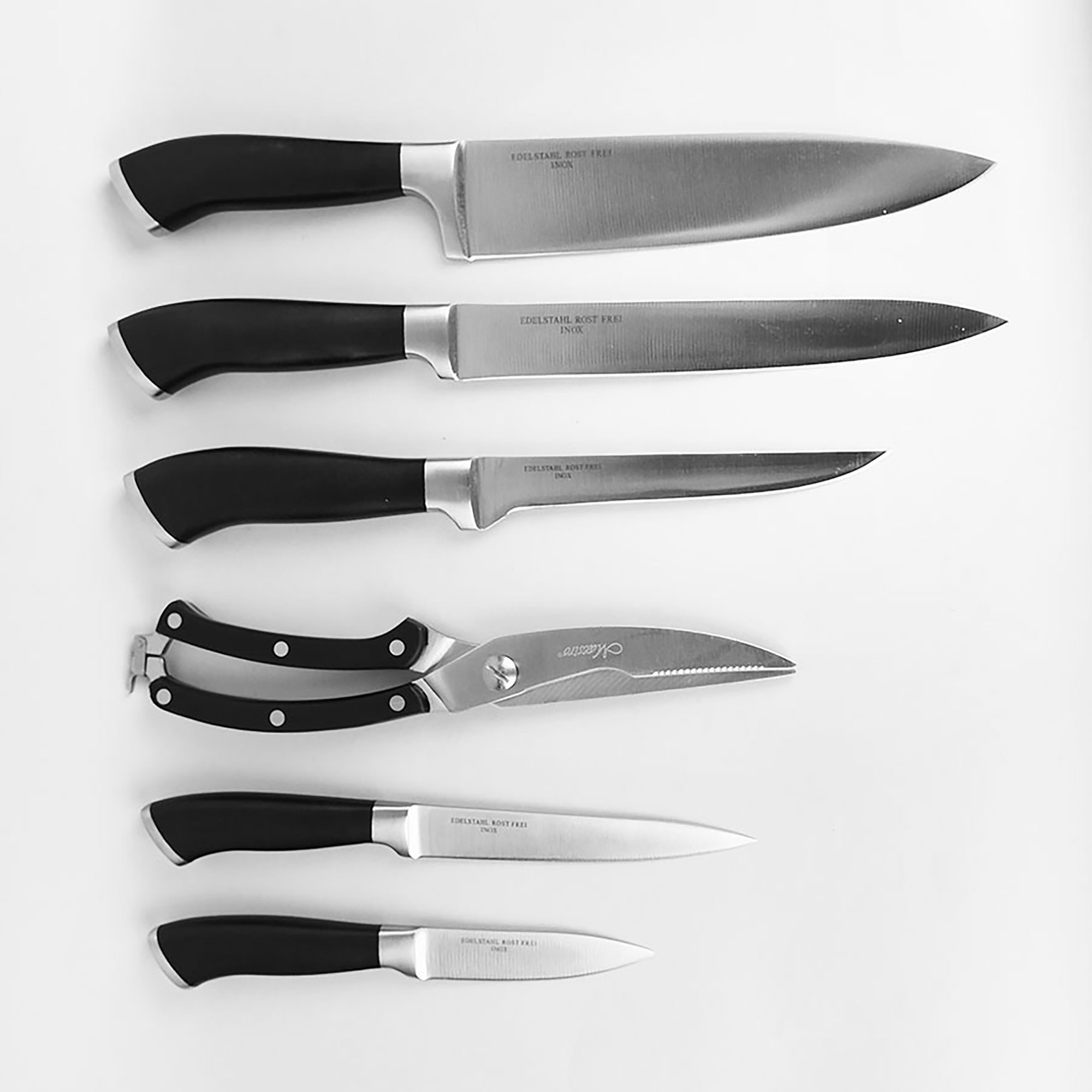 Juego de cuchillos y tijeras de cocina sobre fondo blanco. Los cuchillos tienen mangos negros y hojas plateadas.