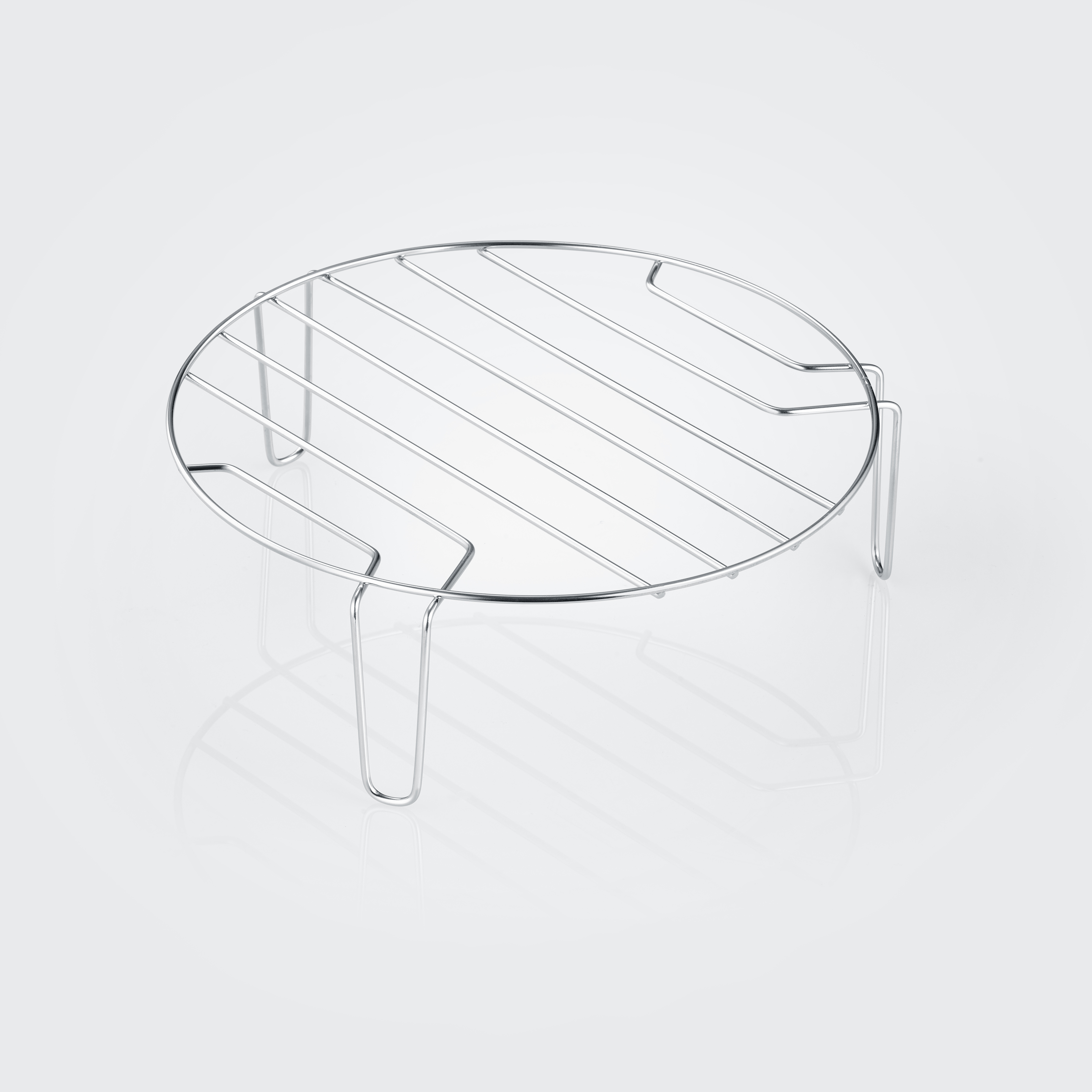 A chrome-colored, round, wire rack with legs, suitable for cooling or supporting items.