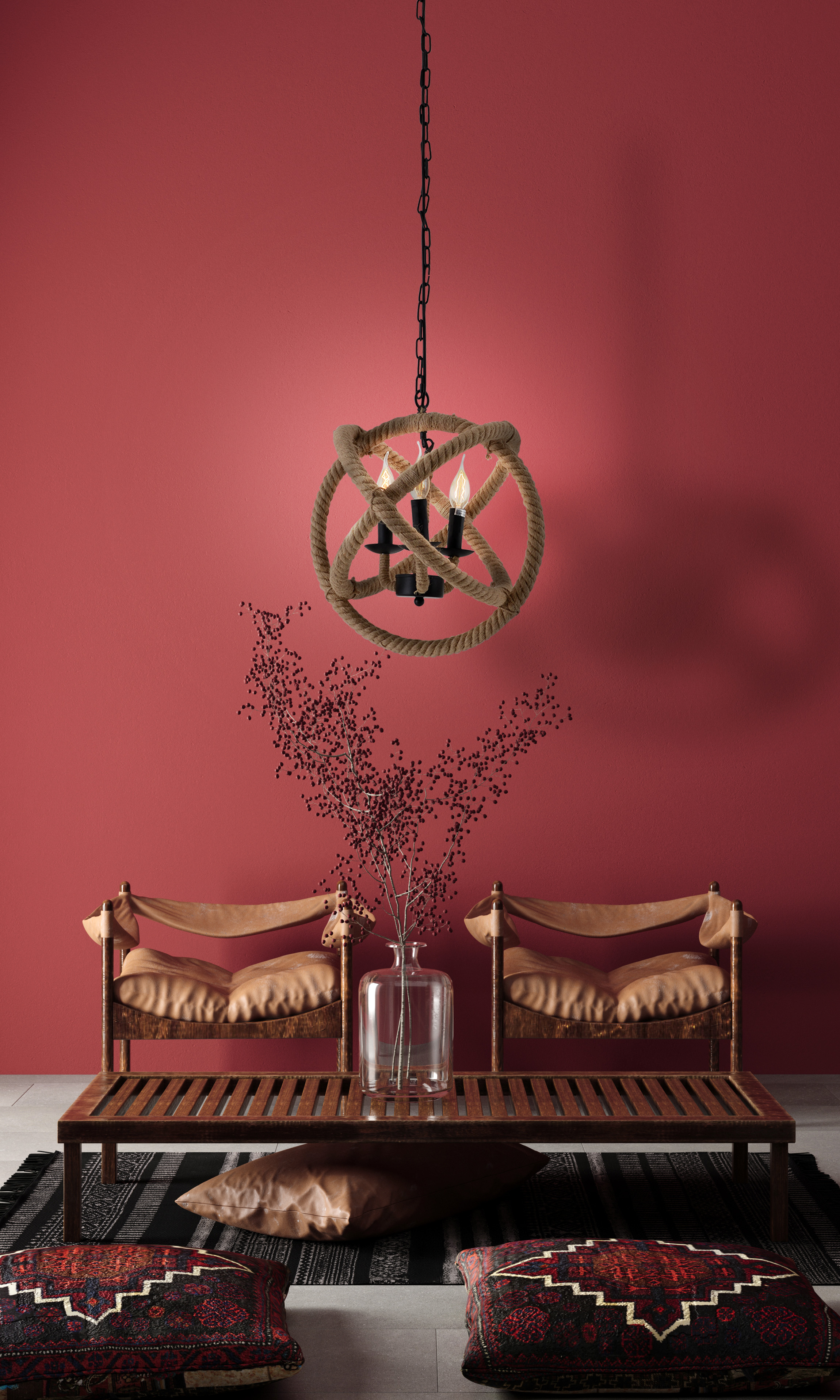 Wohnzimmer mit Seil-Kronleuchter, Tisch, Stühlen und roter Wand.