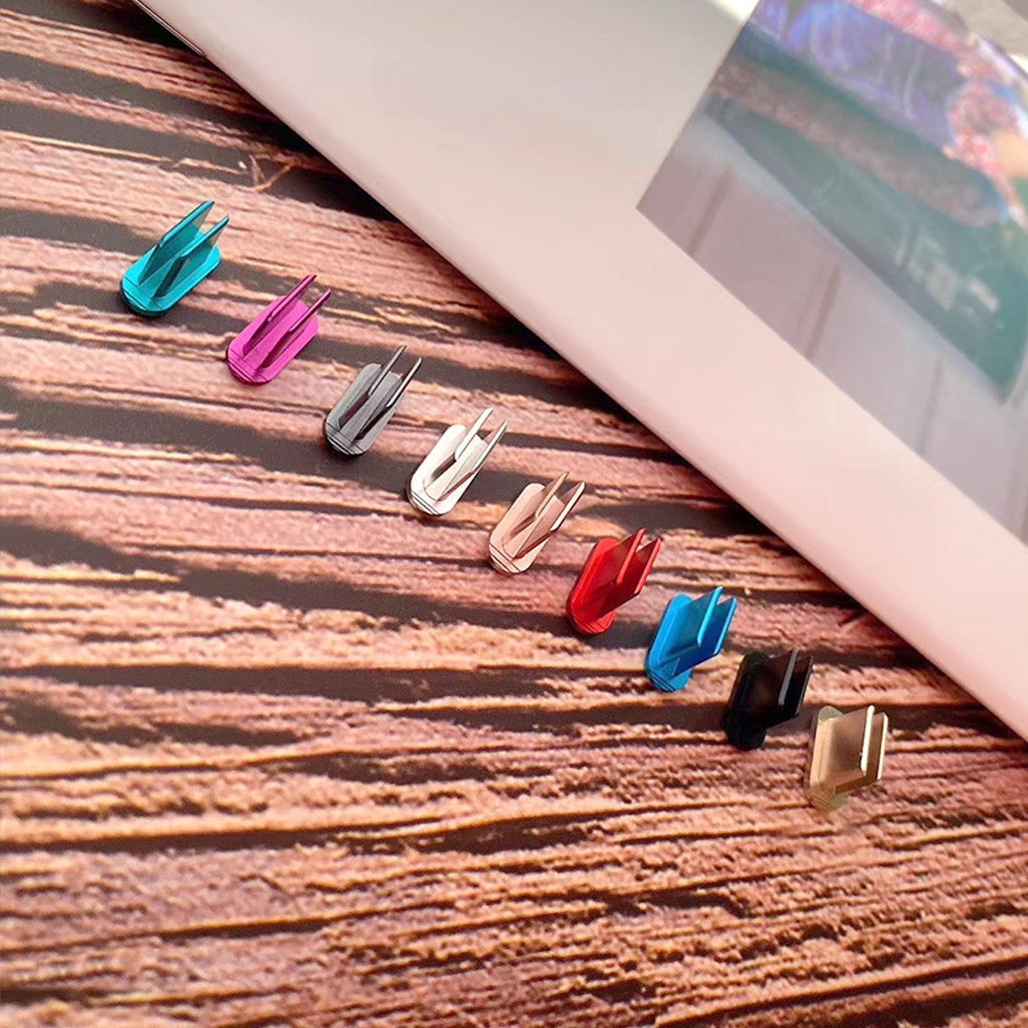 Tappi antipolvere colorati per porte del telefono sono disposti su una superficie di legno.