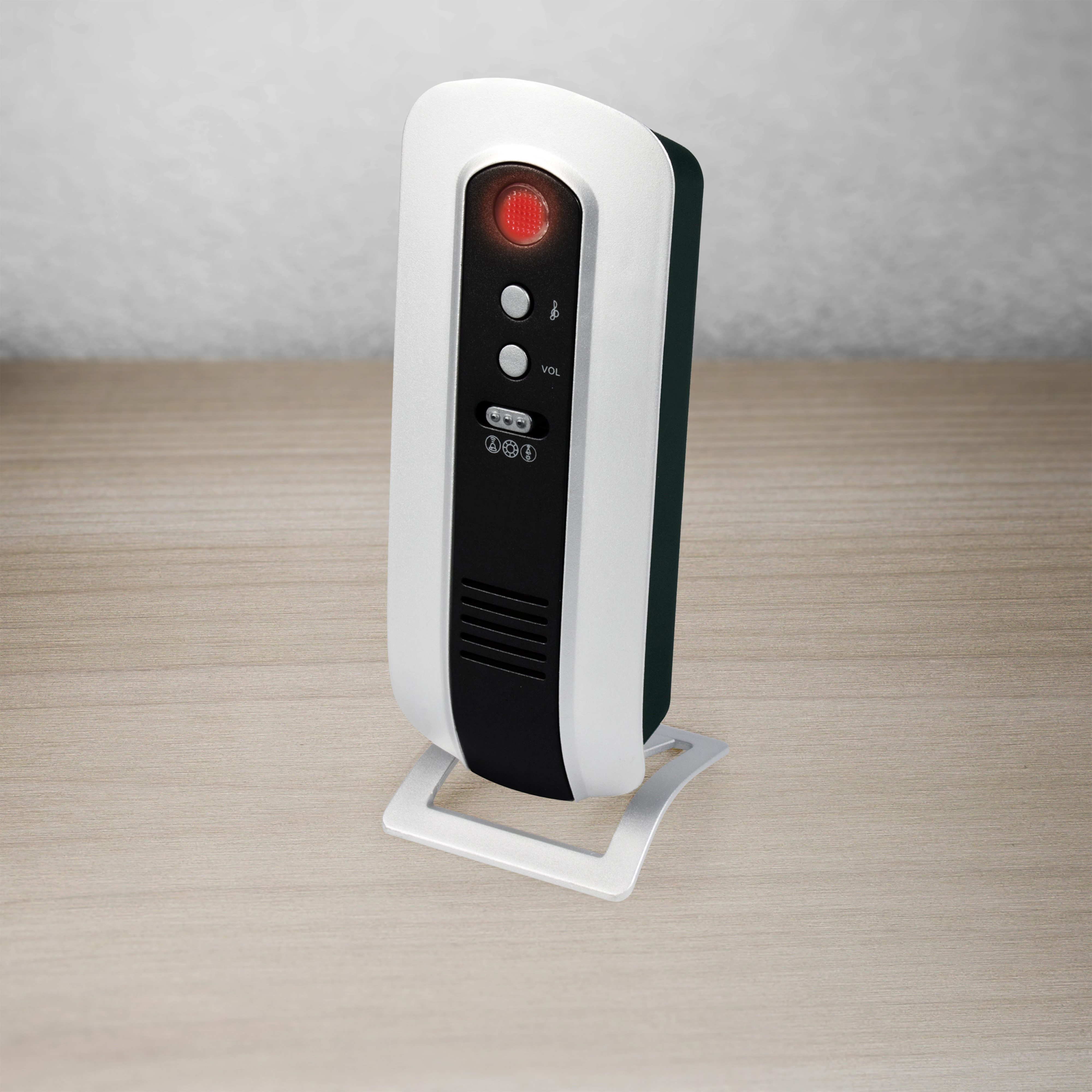 Ein weißes und schwarzes elektronisches Gerät mit rotem Licht oben, stehend auf einem Ständer.