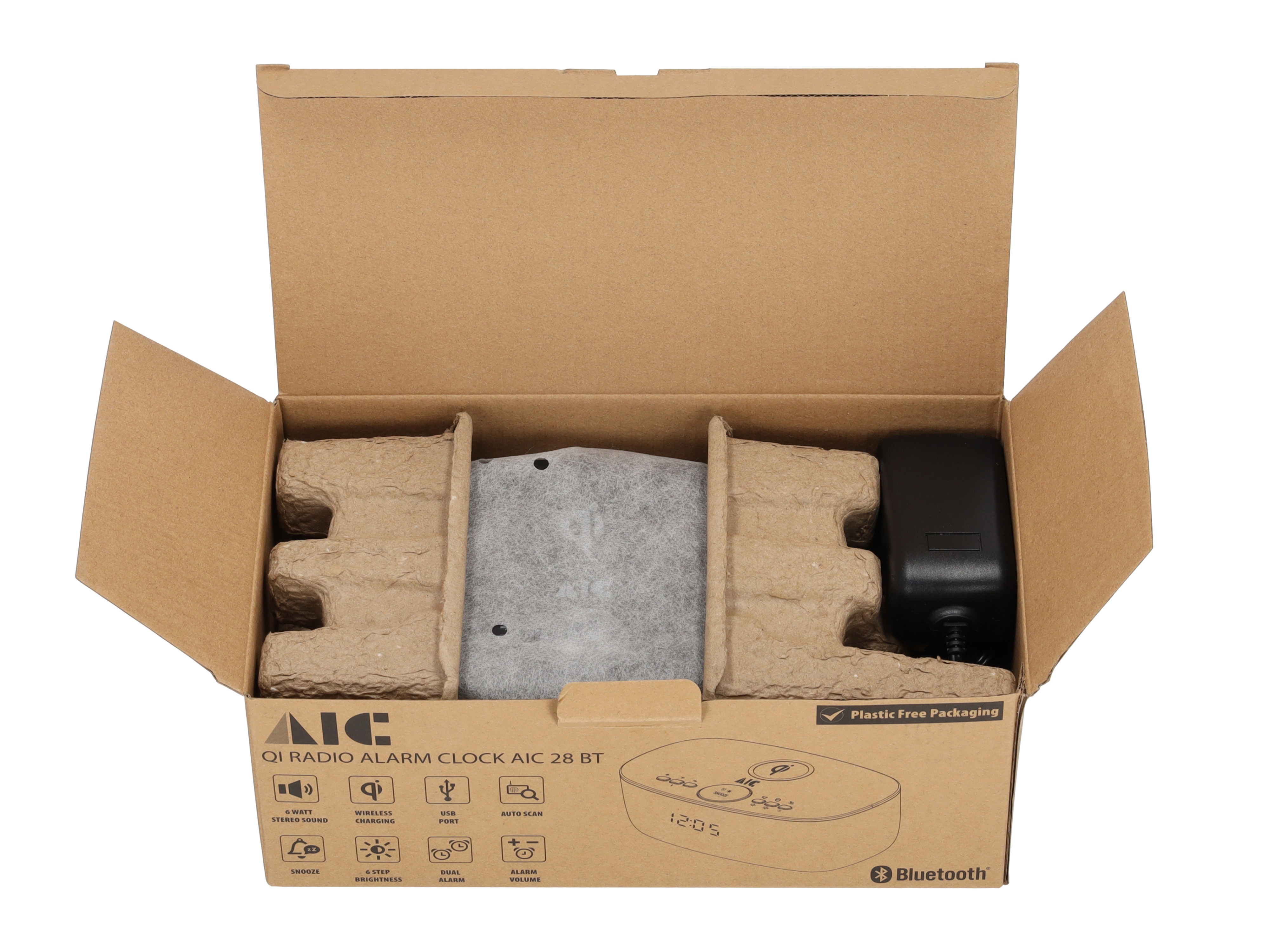 Eine offene Box mit einem Wecker, Netzteil und Verpackungsmaterial. Die Box ist braun.