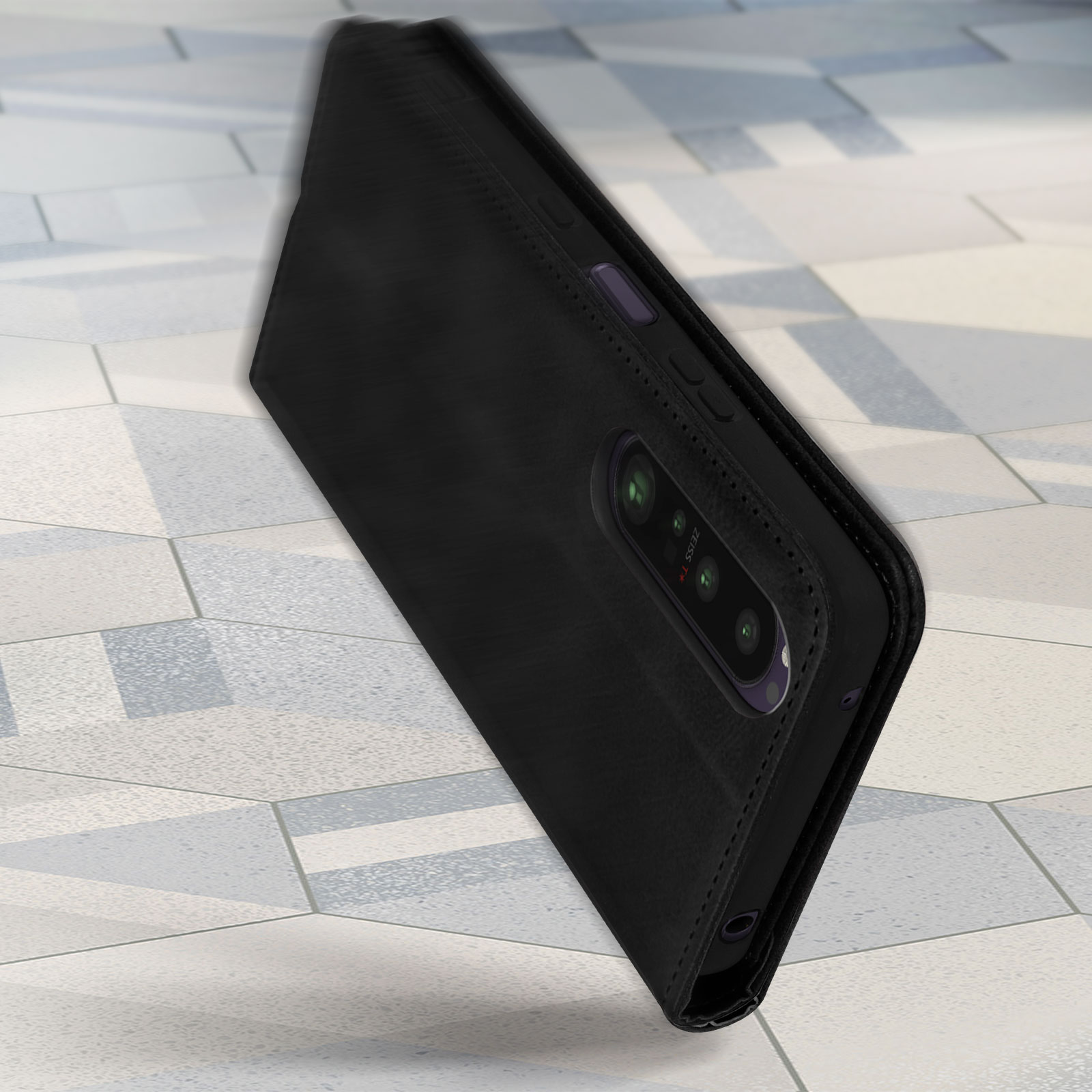 Custodia nera per telefono, texture in pelle, che copre un telefono su una superficie piastrellata.