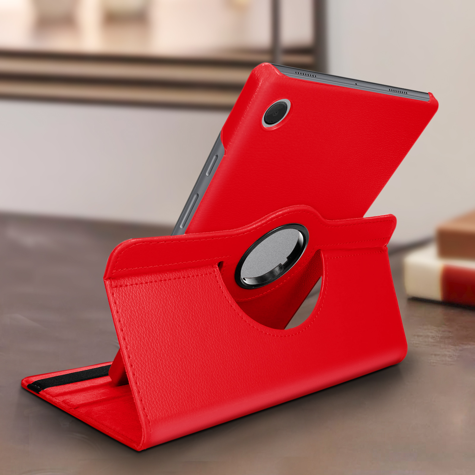 Custodia per tablet rossa in un supporto. Il tablet è visibile. Il supporto è su una superficie di legno.