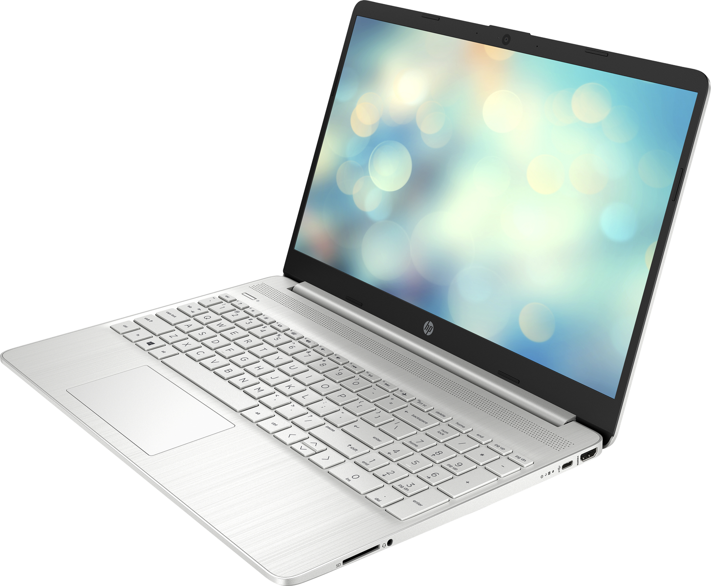 Laptop plateado en ángulo. La pantalla muestra un fondo suave con luces borrosas.