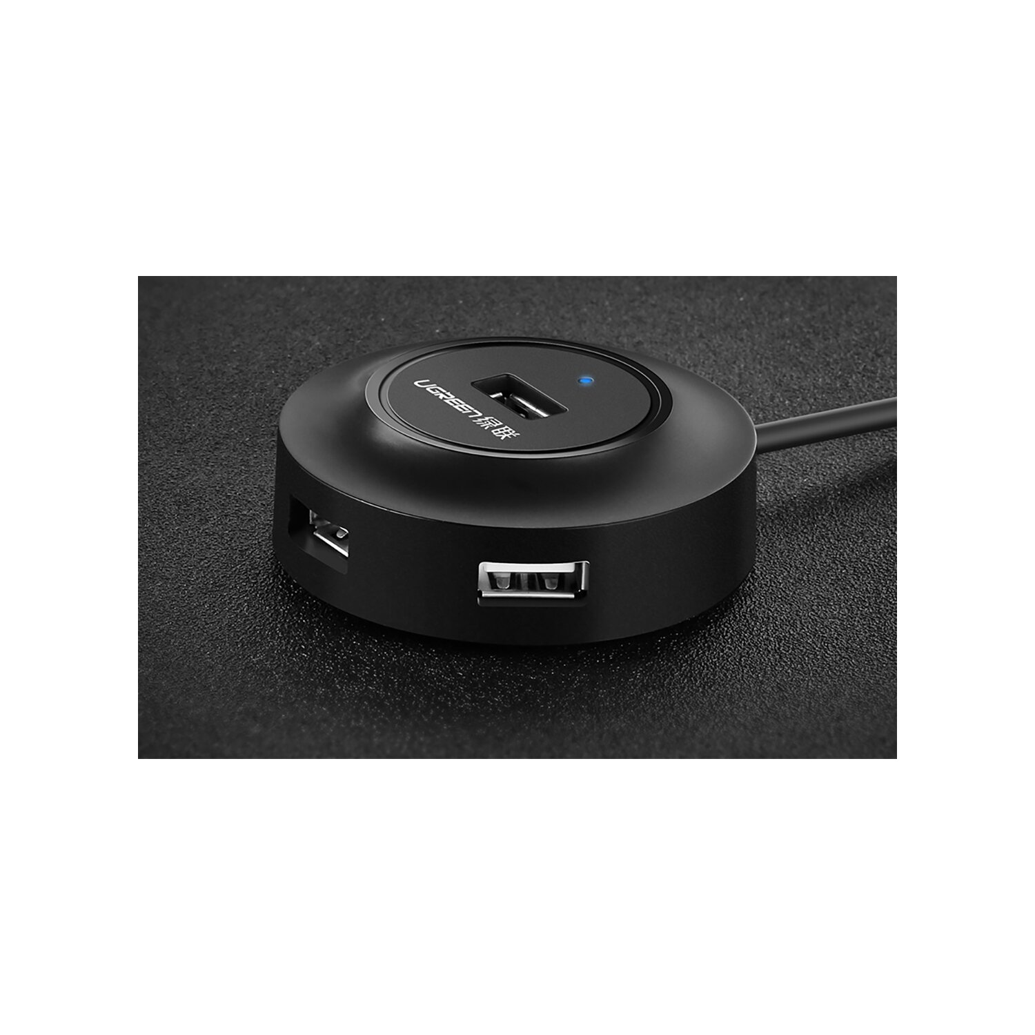 Schwarzer USB-Hub mit mehreren Anschlüssen auf dunkler Oberfläche.