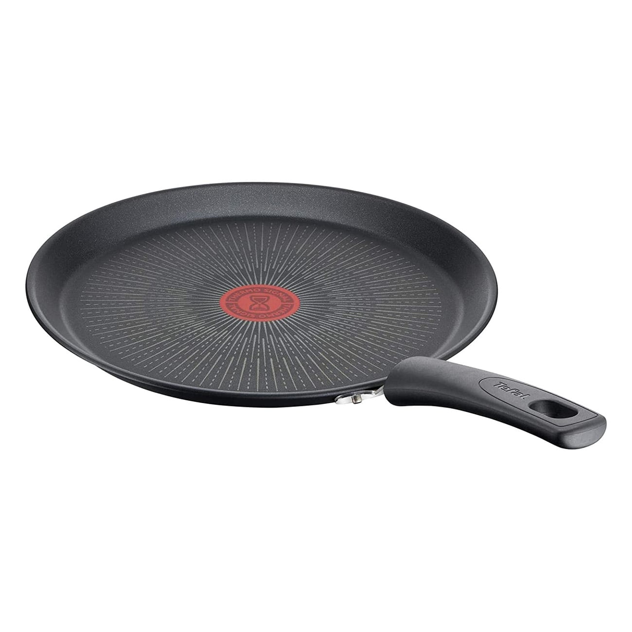 Czarna patelnia z uchwytem. Czerwone i białe okręgi na środku.