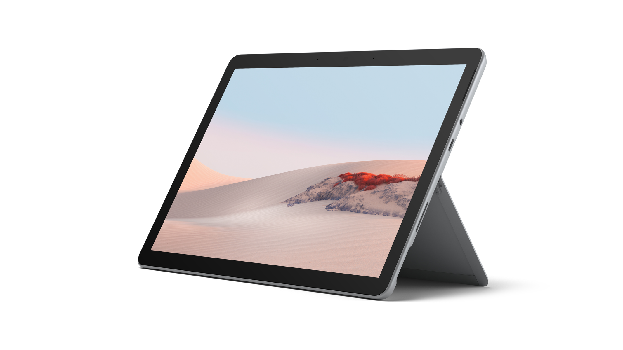 Tablet grigio con supporto, aperto, mostra un paesaggio desertico.