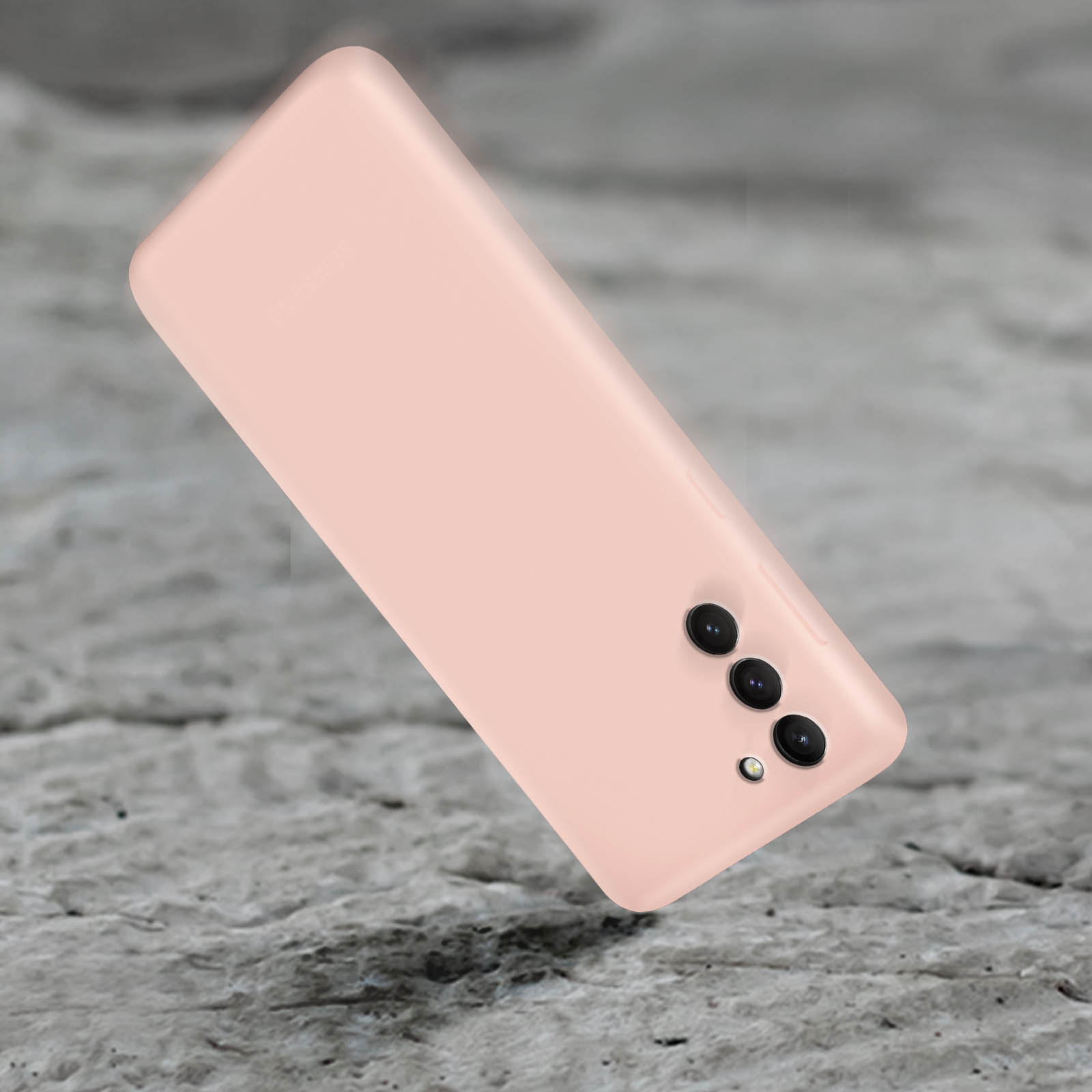 Rückseite eines pinkfarbenen Smartphones mit drei Kameralinsen. Auf grauer Oberfläche.