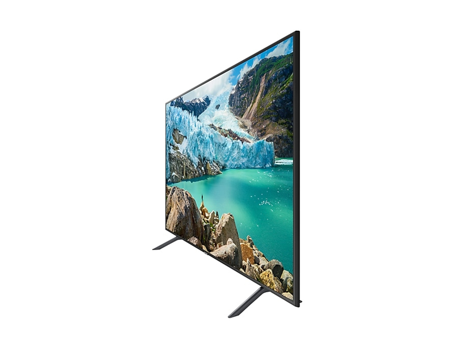 Un televisor muestra una escena montañosa con un lago turquesa y picos nevados. El televisor tiene patas negras.