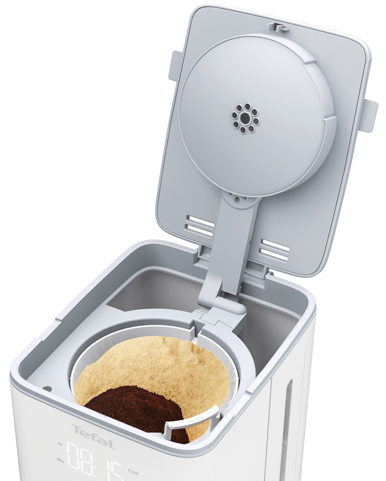 Biały ekspres do kawy z otwartą pokrywą pokazującą zmieloną kawę w filtrze.